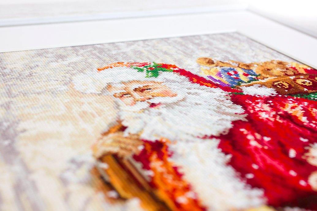 Santa Claus B575L Counted Cross-Stitch Kit featuring Santa with gifts in a winter landscape, includes Aida canvas and 45 colors.