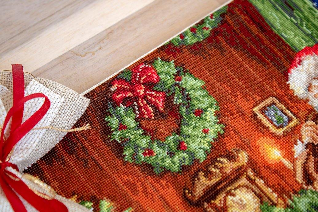 Santa Claus B578L Counted Cross-Stitch Kit featuring Aida canvas, colorful threads, and needle for holiday crafting.