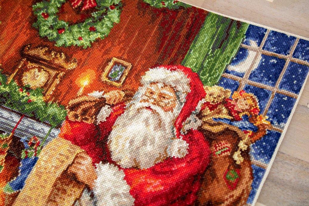 Santa Claus B578L Counted Cross-Stitch Kit featuring Aida canvas, colorful threads, and needle for holiday crafting.