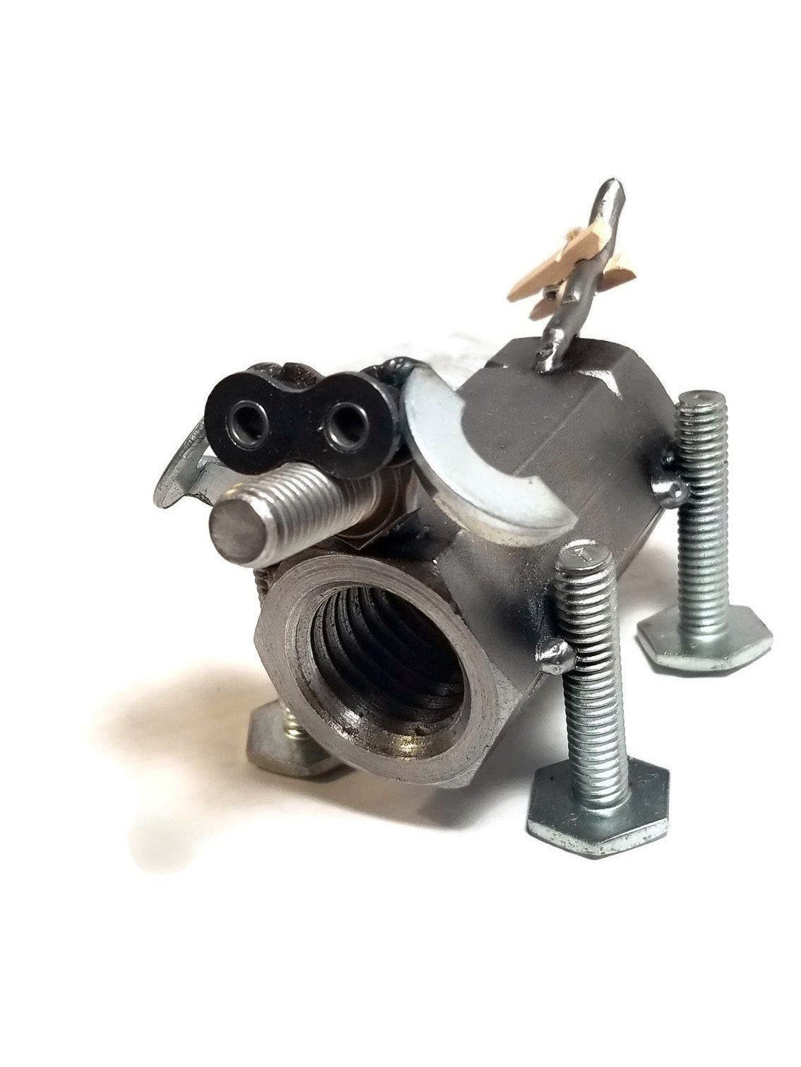 A handcrafted scrap metal dog figurine made from nuts, bolts, and other metal parts, showcasing a rustic and artistic design, perfect for home decor.