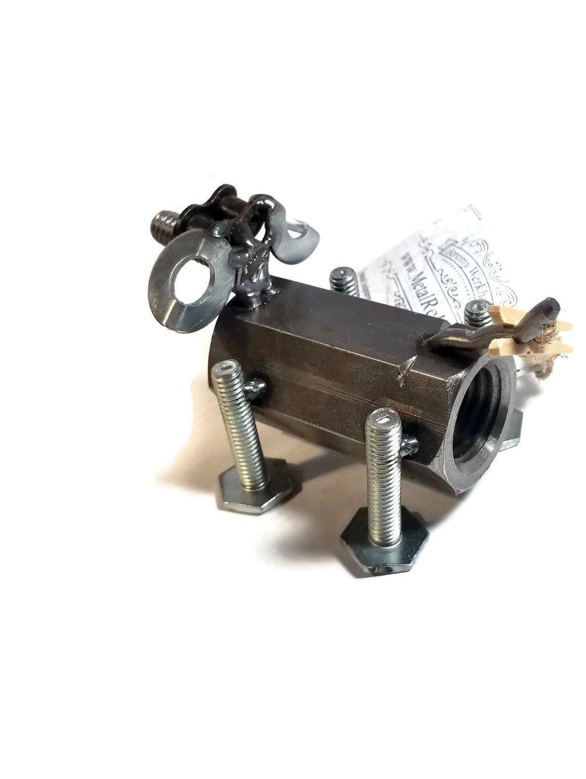 A handcrafted scrap metal dog figurine made from nuts, bolts, and other metal parts, showcasing a rustic and artistic design, perfect for home decor.