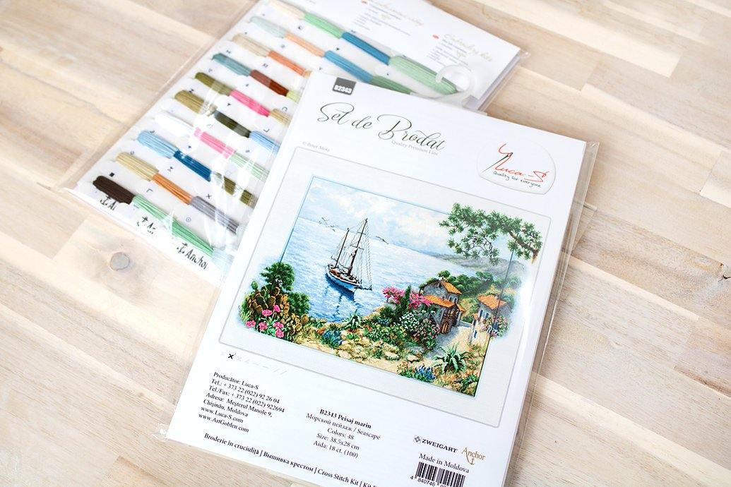 Seascape B2343L Counted Cross-Stitch Kit featuring Aida canvas, colorful threads, and needle for crafting.
