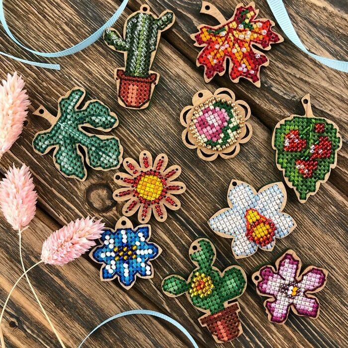 Set of 20 wooden embroidery blanks with intricate designs, perfect for creative needlework projects.