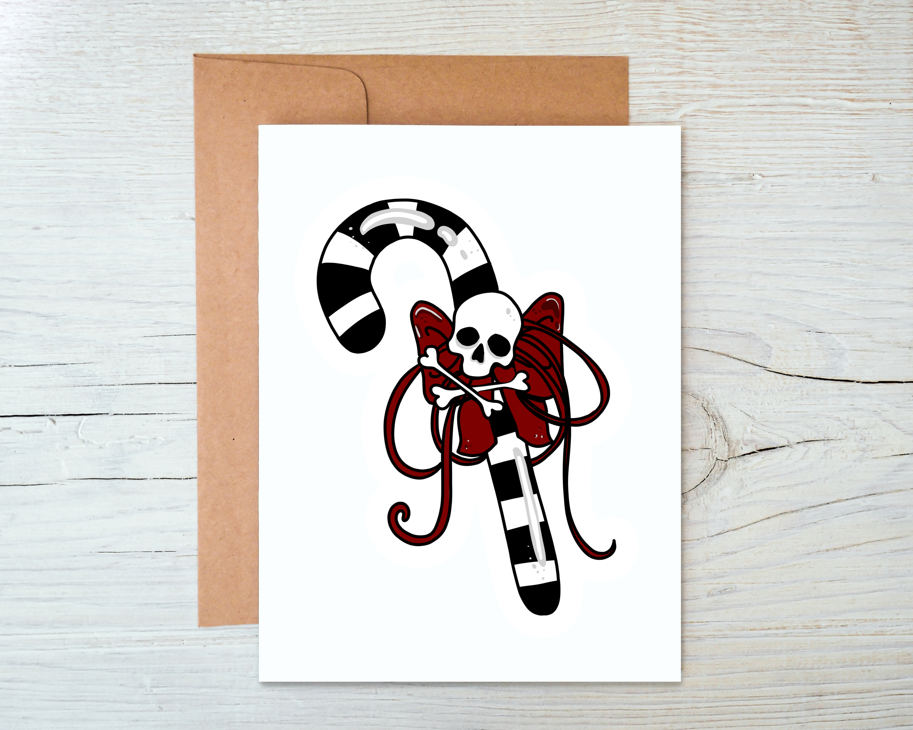 Skull Candy Cane Card featuring a festive candy cane design, blank inside, accompanied by a kraft envelope.