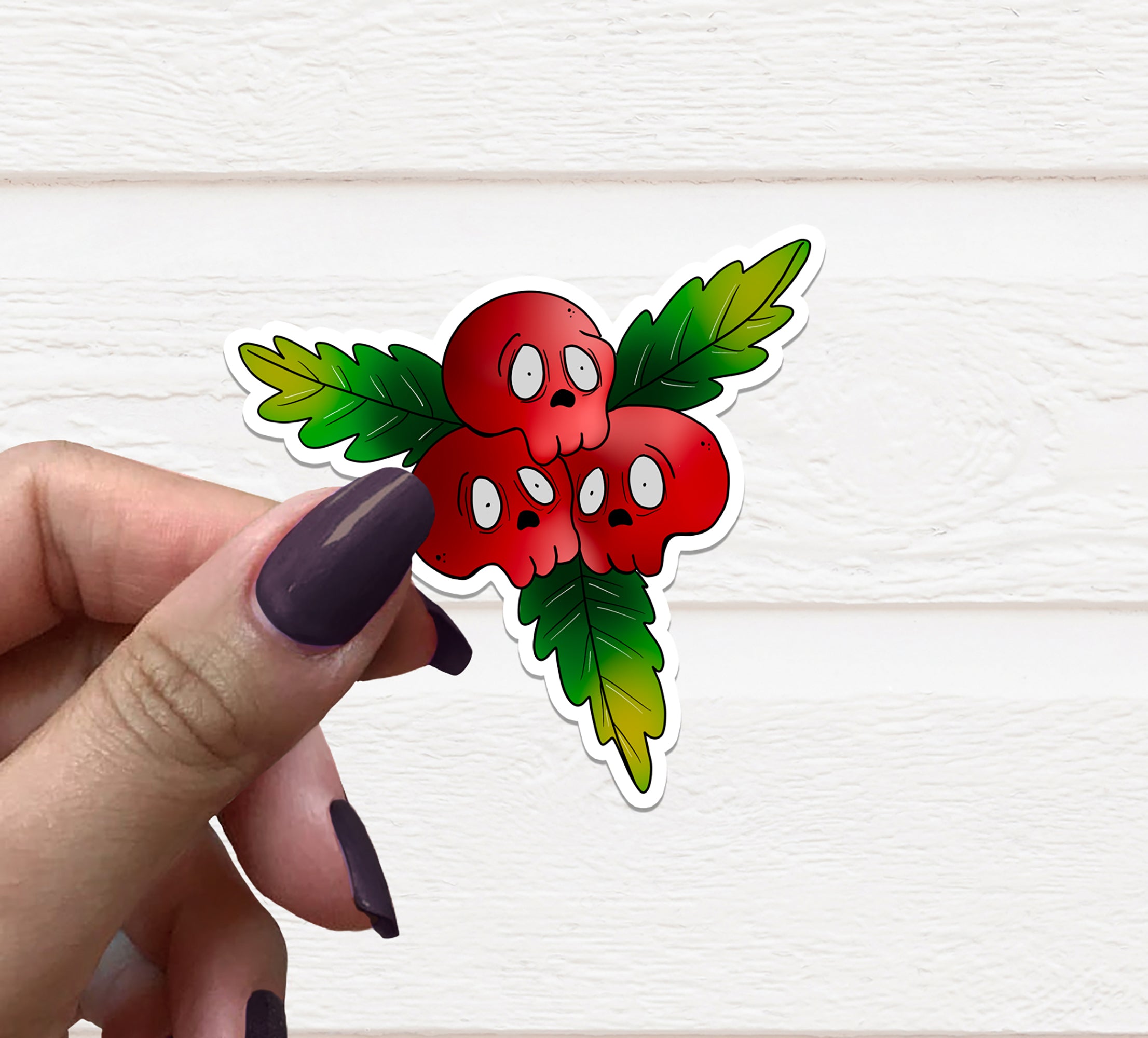 A vibrant Skull Holly Vinyl Sticker featuring a skull design adorned with holly leaves, perfect for festive decorations.