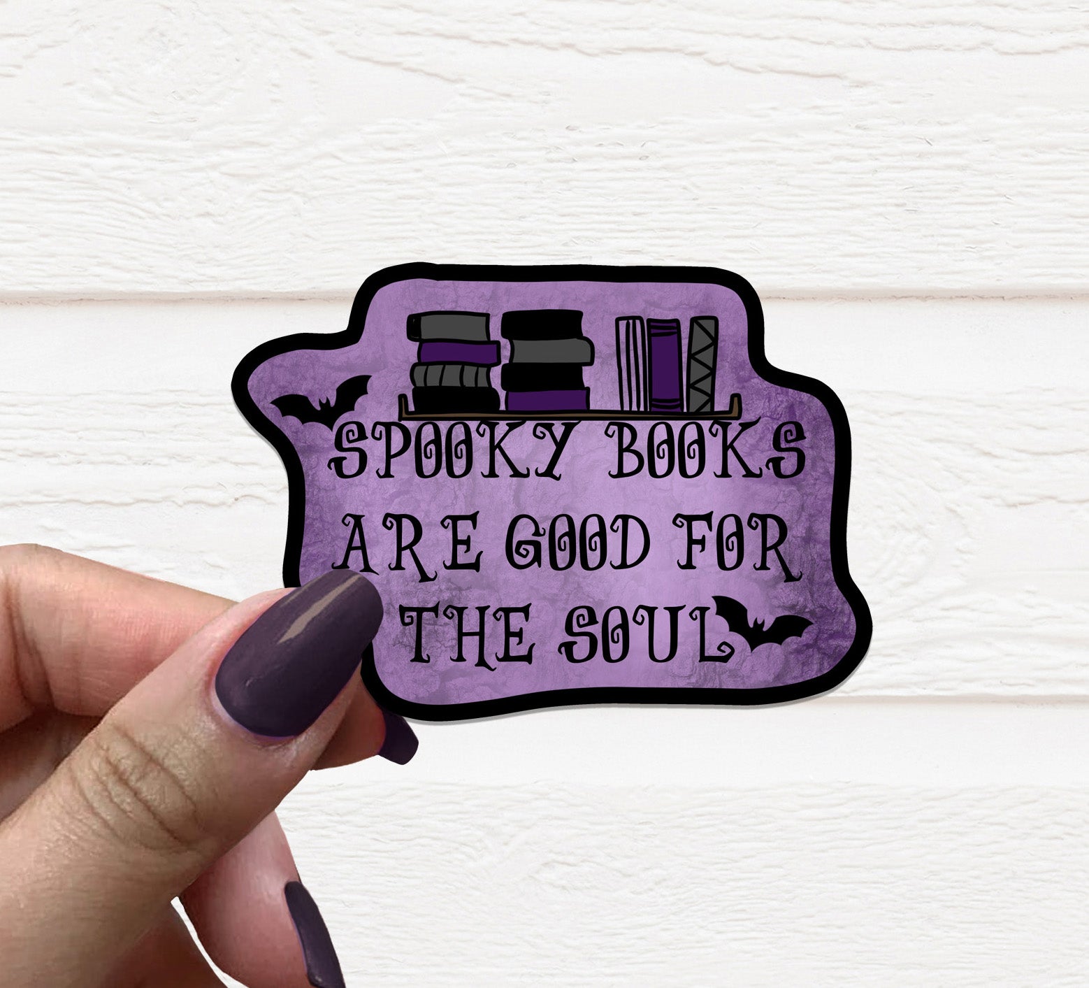 A vibrant 3.5-inch Spooky Books Vinyl Sticker featuring spooky book designs, perfect for personalizing various items.
