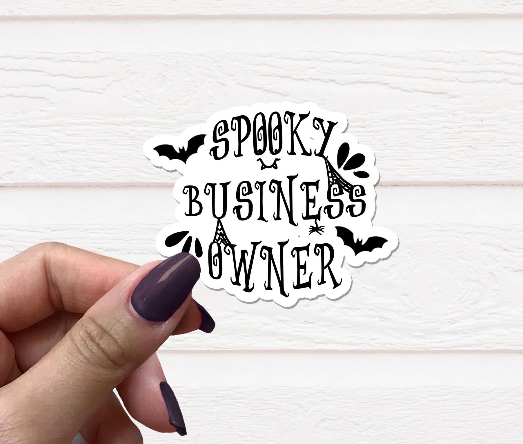 A vibrant Spooky Business Owner Vinyl Sticker featuring a playful design, perfect for personalizing various items like laptops and water bottles.