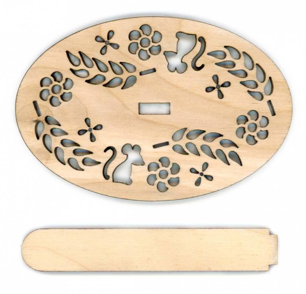 A cutout plywood display stand for cross-stitch projects, measuring 9x6 cm, showcasing intricate designs.