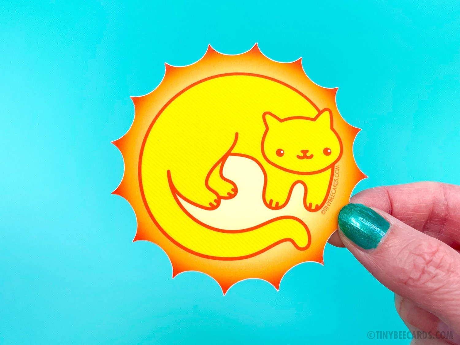 A vibrant vinyl sticker featuring a cute sun cat design, perfect for personalizing items.