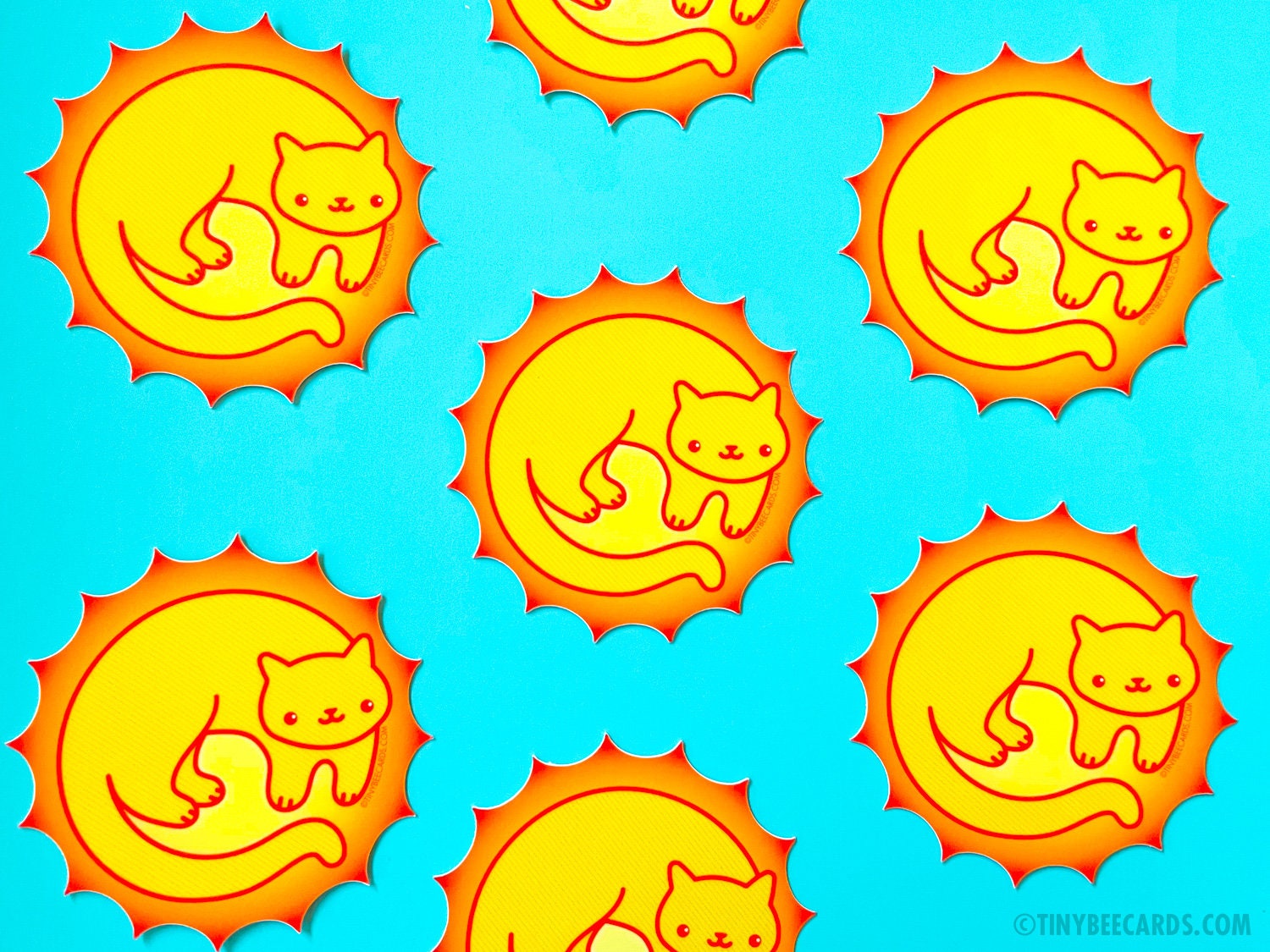 A vibrant vinyl sticker featuring a cute sun cat design, perfect for personalizing items.