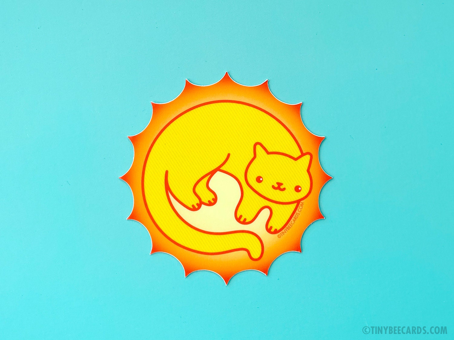 A vibrant vinyl sticker featuring a cute sun cat design, perfect for personalizing items.
