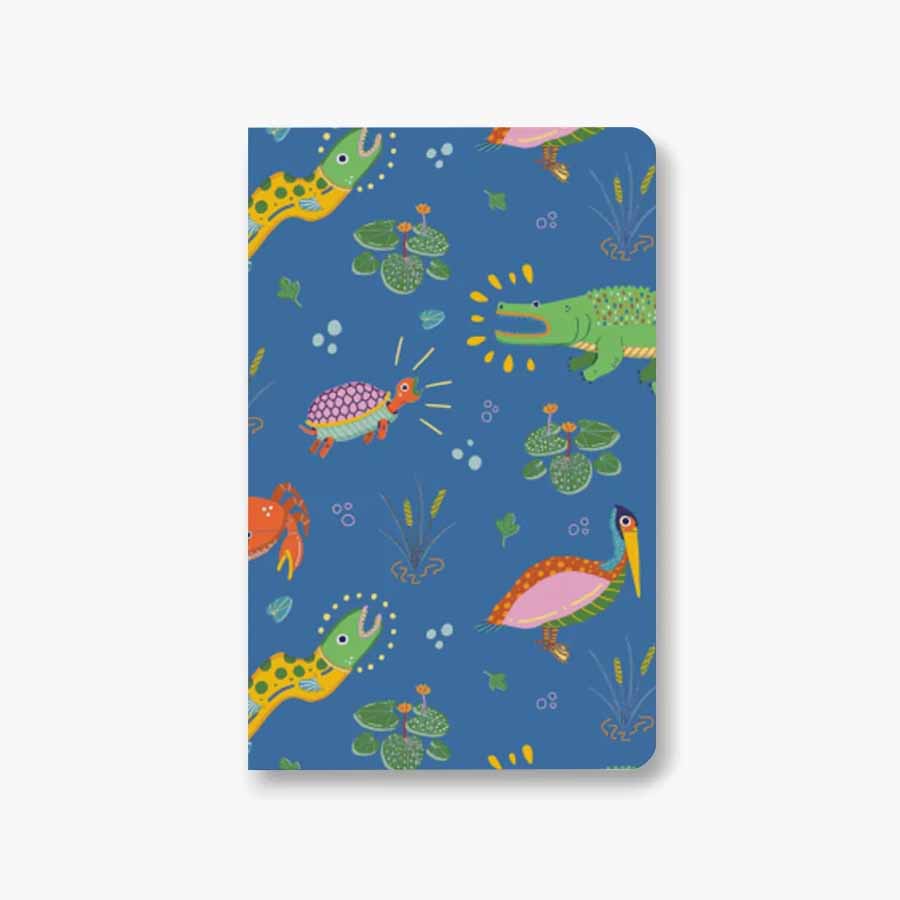Swamp Softcover Pocket Notebook featuring wetland creatures design by Erwin Ong, showcasing its water-resistant cover and compact size.