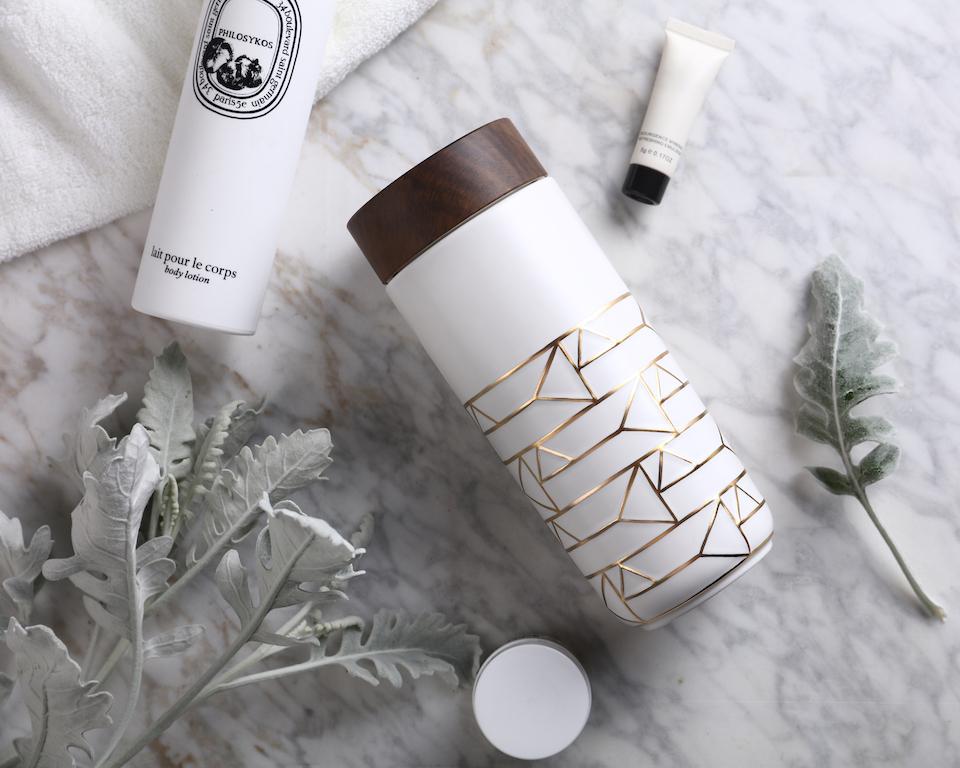 The Alchemical Signs Gold Ceramic Travel Mug featuring a vibrant gold hand-painted design with geometric patterns inspired by ancient alchemical symbols.