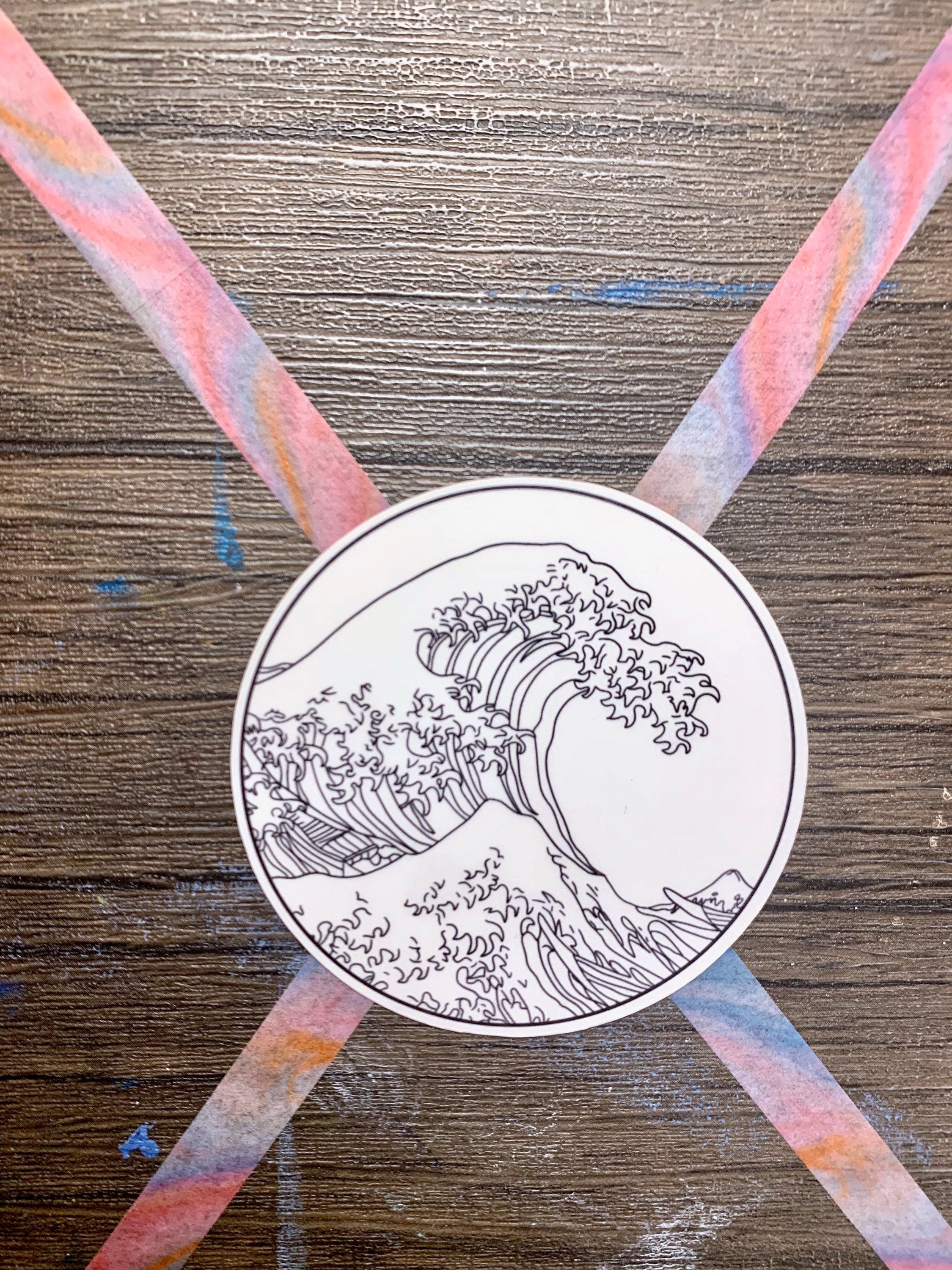 A vibrant sticker featuring The Great Wave off Kanagawa artwork, perfect for personalizing items.