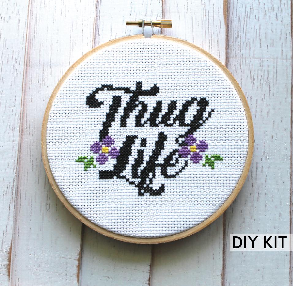 Thug Life Counted Cross Stitch DIY Kit featuring floral elements and cursive lettering.