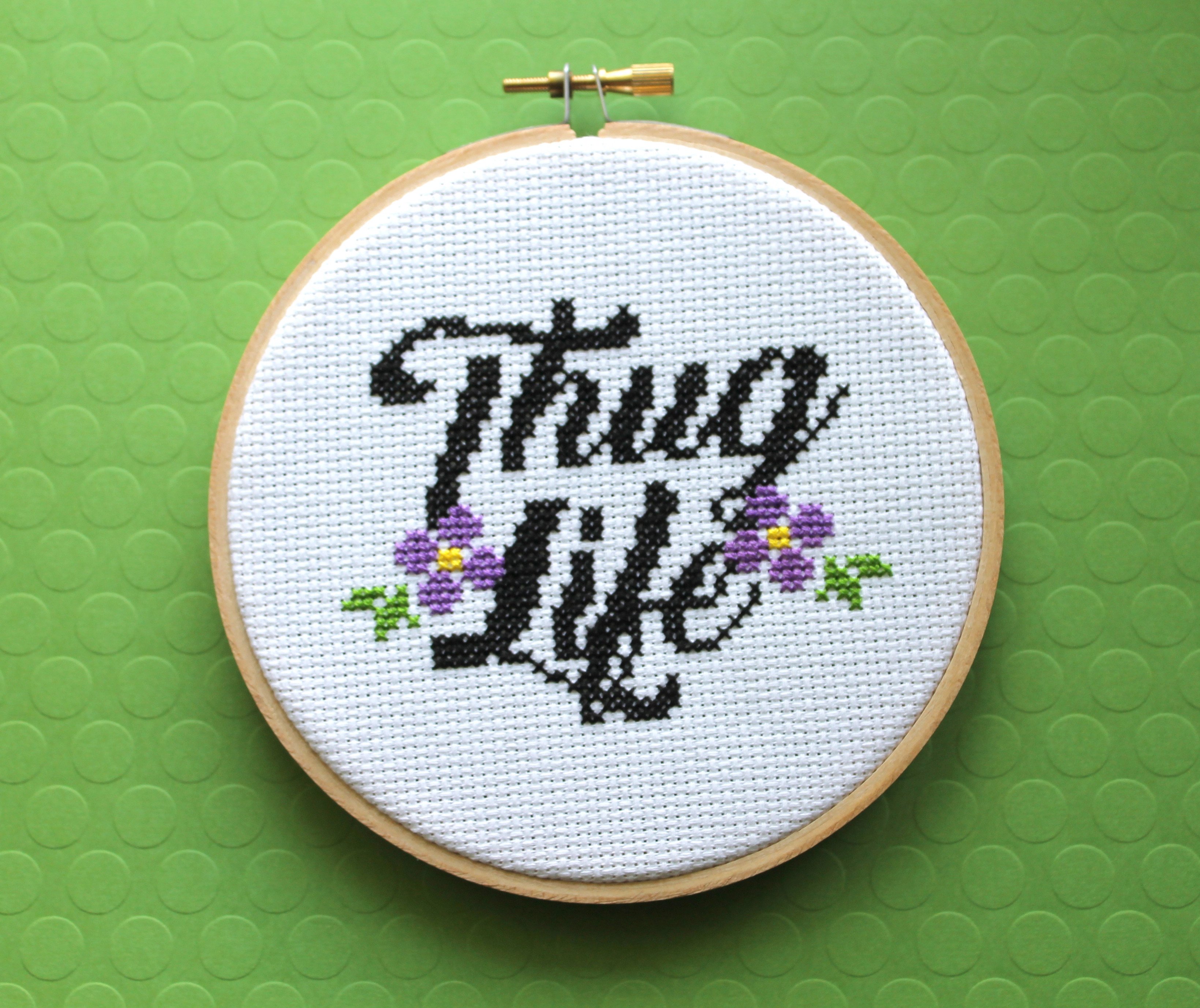 Thug Life Counted Cross Stitch DIY Kit featuring floral elements and cursive lettering.