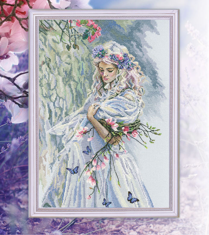 Tree Nymph M725 Counted Cross Stitch Kit featuring grey-blue Aida fabric, colorful threads, and included stitching tools.