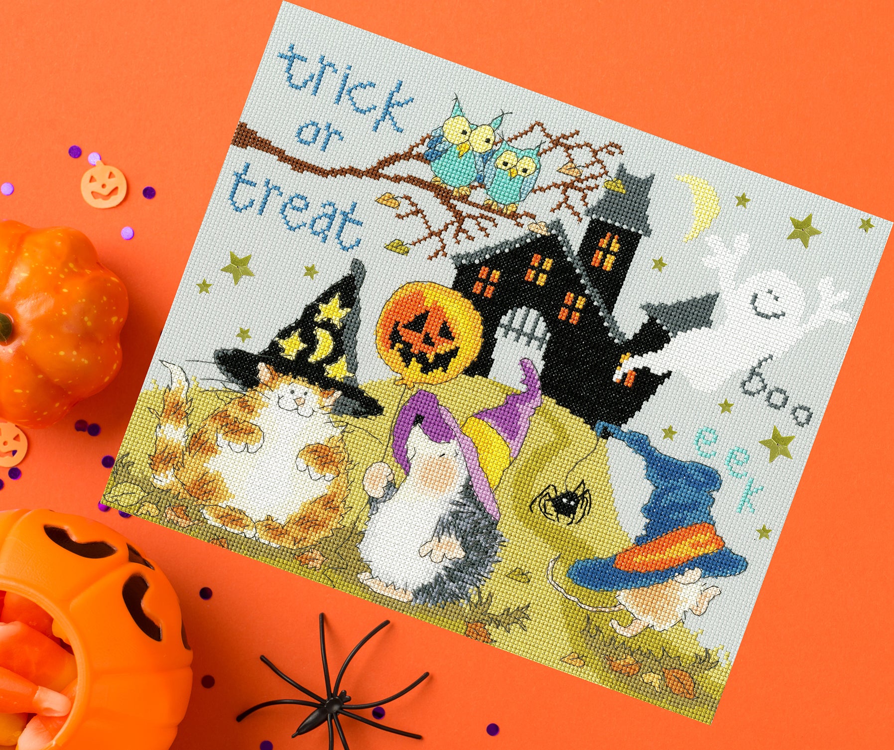 Trick Or Treat XMS29 Counted Cross Stitch Kit featuring misty blue Aida fabric, glow in the dark thread, and star sequins.