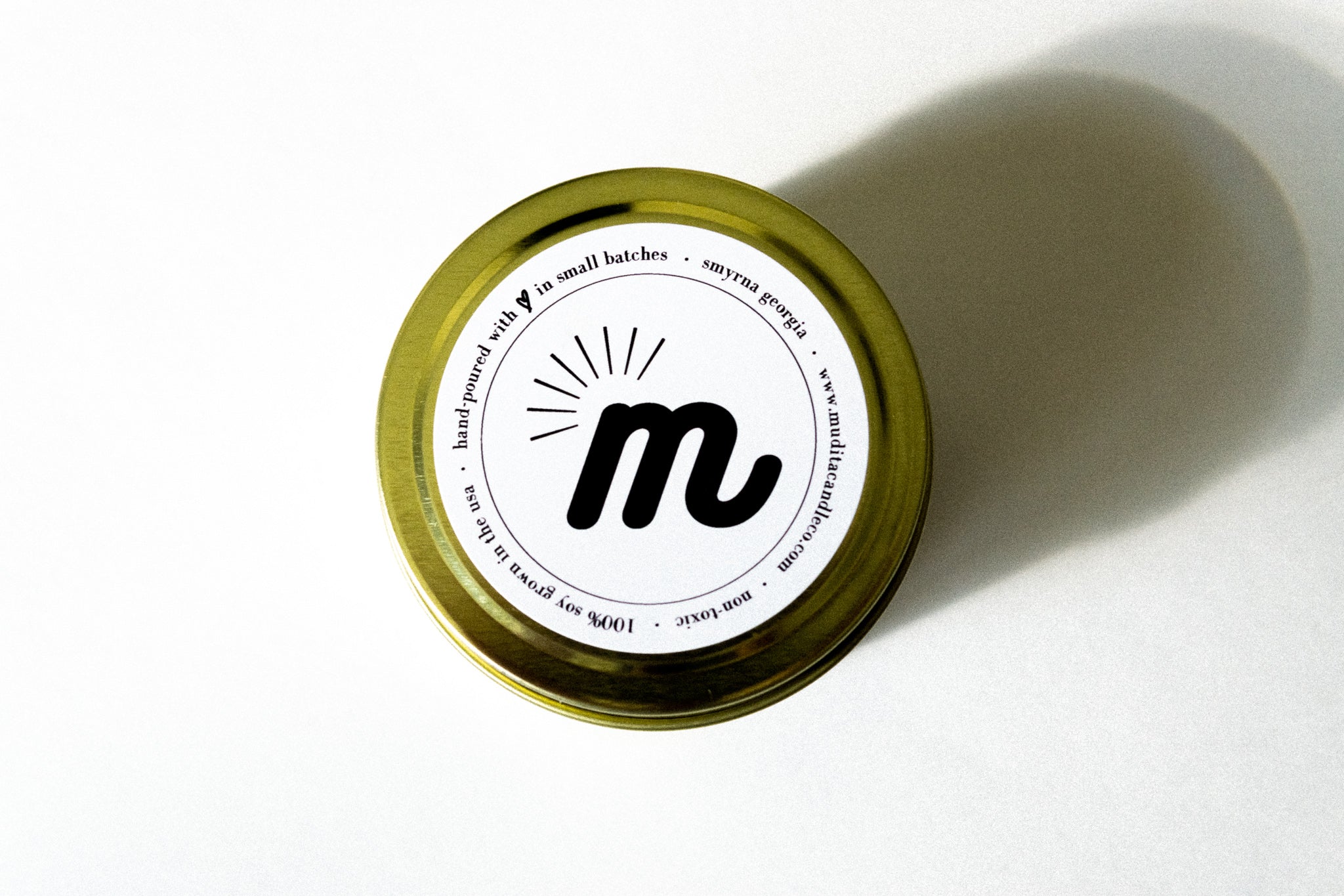 Tropical Tropicana Gold Travel Candle in a gold tin jar, featuring a blend of peach, mango, pineapple, and coconut milk scents.