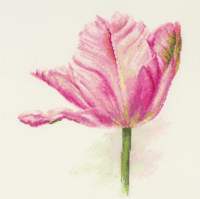 Light pink tulips cross-stitch kit with threads, needle, and fabric.