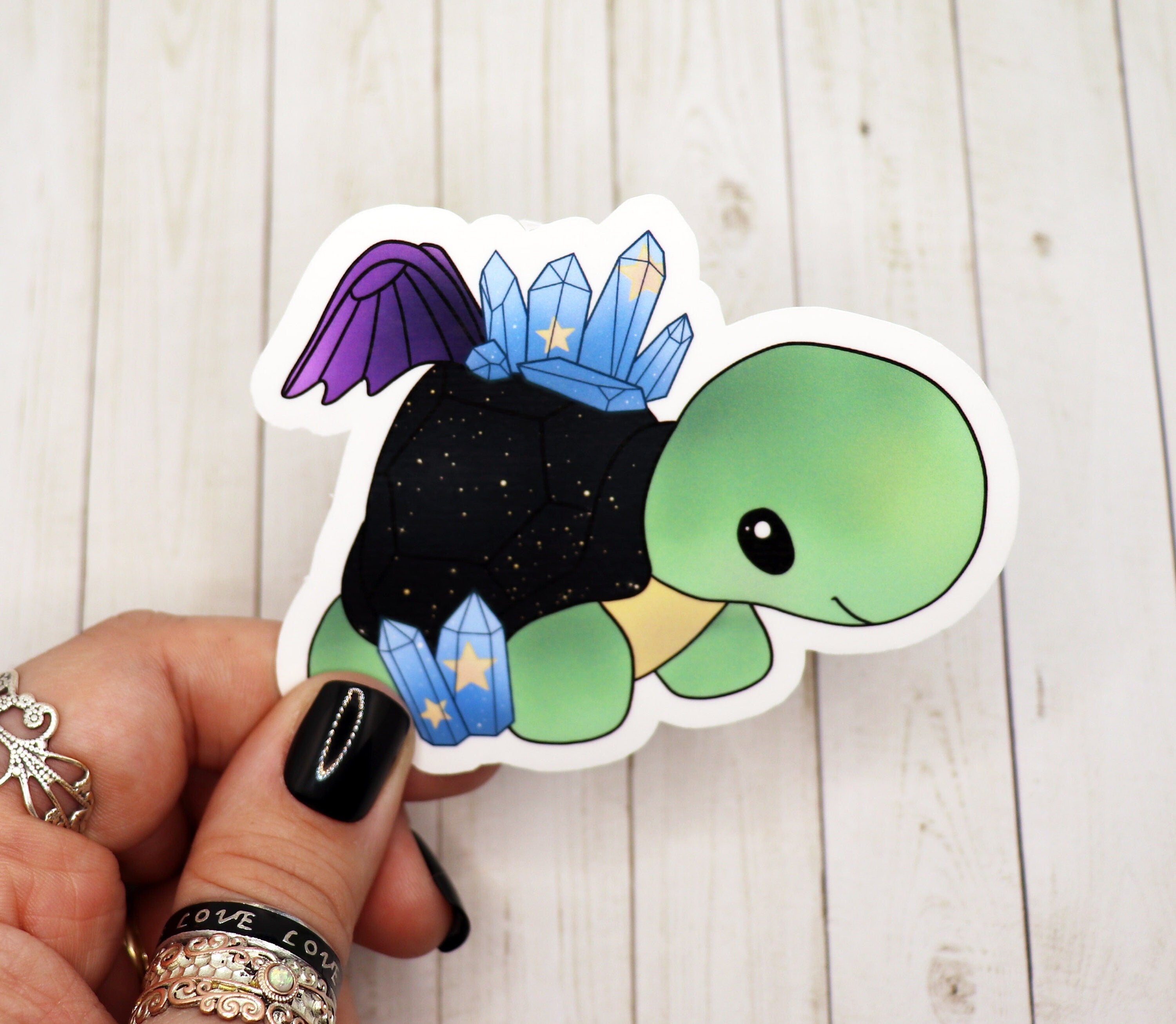 A cute turtle stuffed animal sticker with fairy wings, showcasing vibrant colors and a whimsical design.