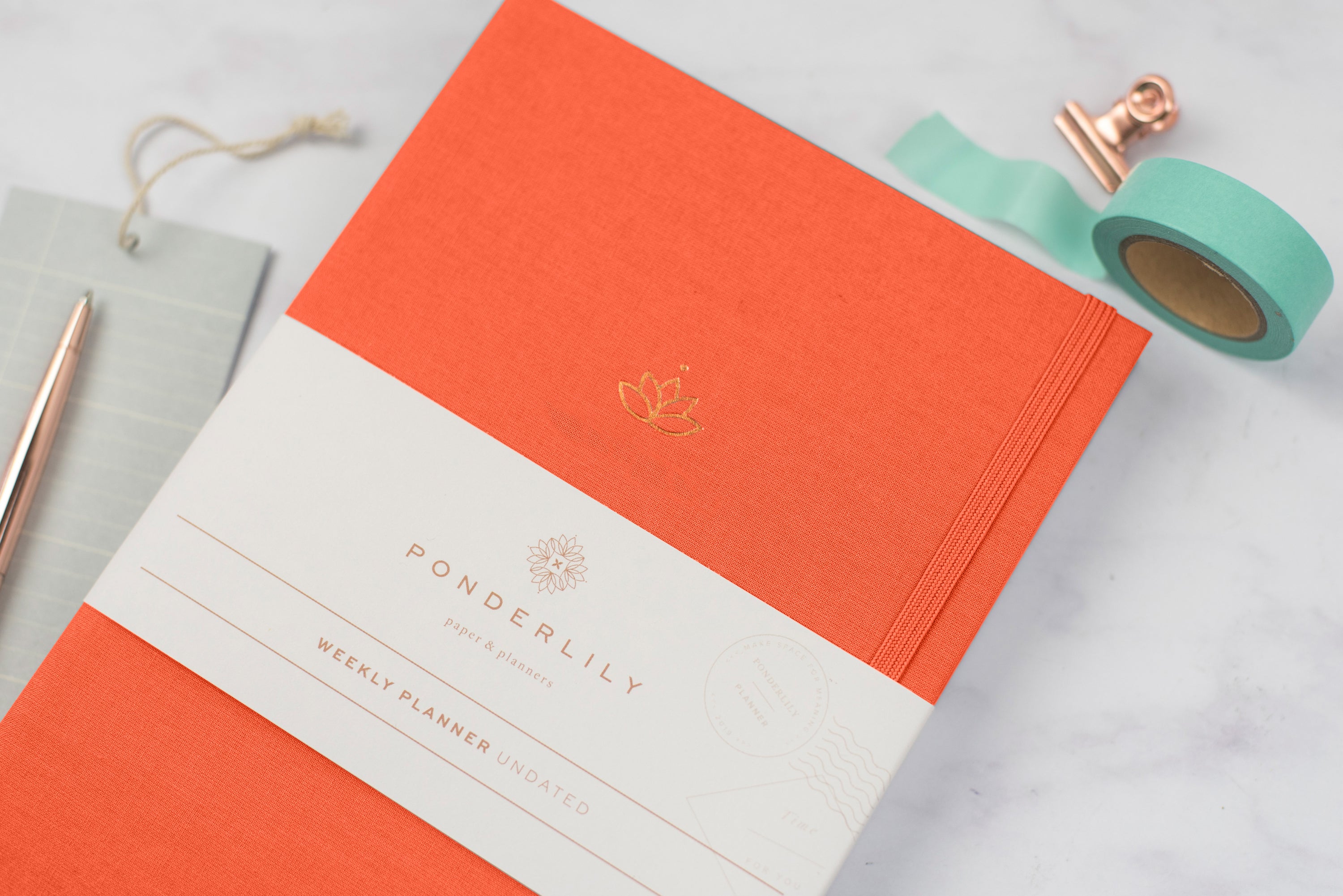 Undated Weekly Ponderlily Planner in Cayenne, featuring an elegant design with eco-conscious materials and flexible planning options.