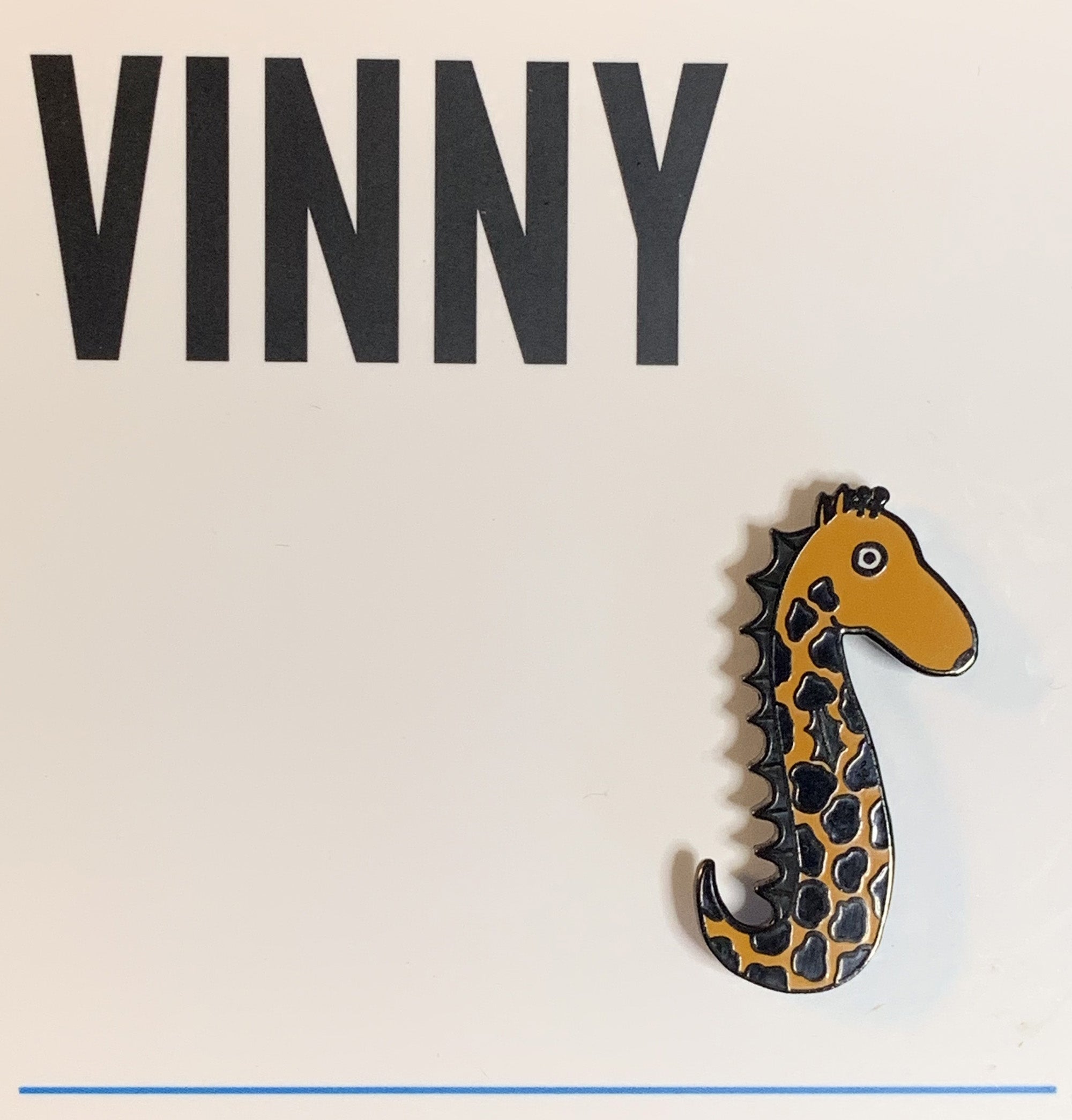 Vinny the Seahorse Giraffe enamel pin featuring a whimsical design with vibrant colors and a nickel-plated metal backing.