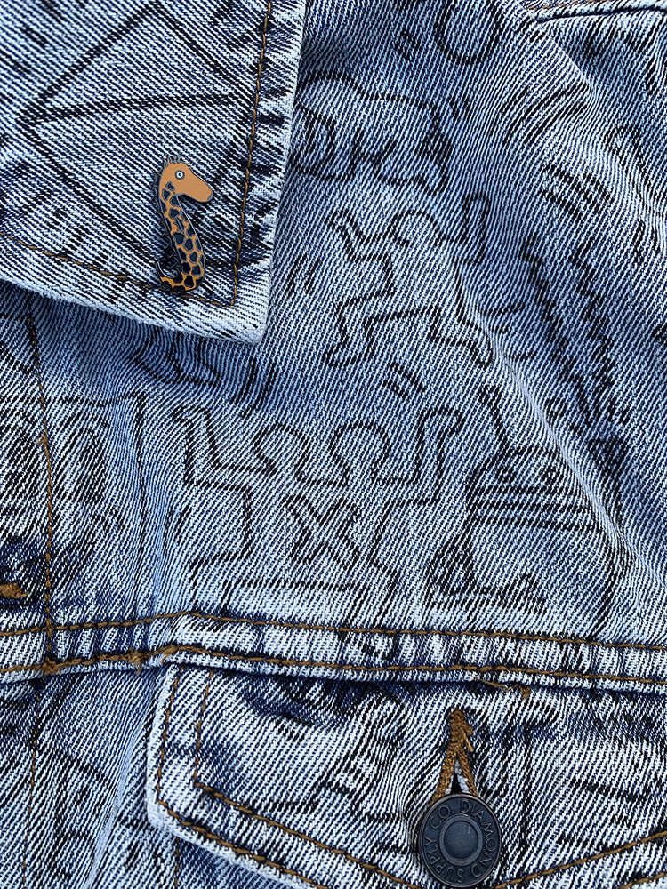 Vinny the Seahorse Giraffe enamel pin featuring a whimsical design with vibrant colors and a nickel-plated metal backing.