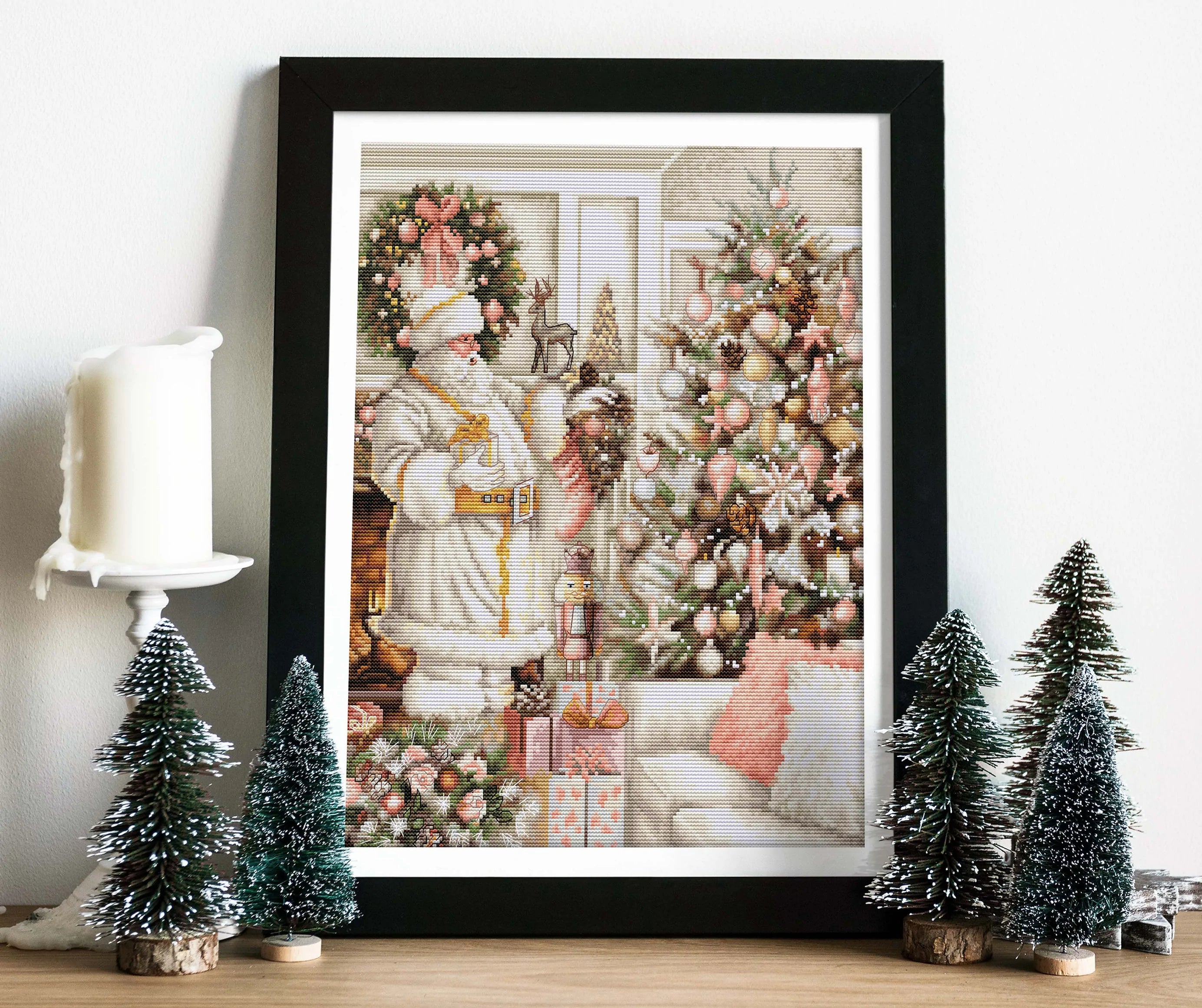 A counted cross-stitch kit featuring a white Santa Claus with a Christmas tree, including Aida canvas, colorful threads, and a needle.