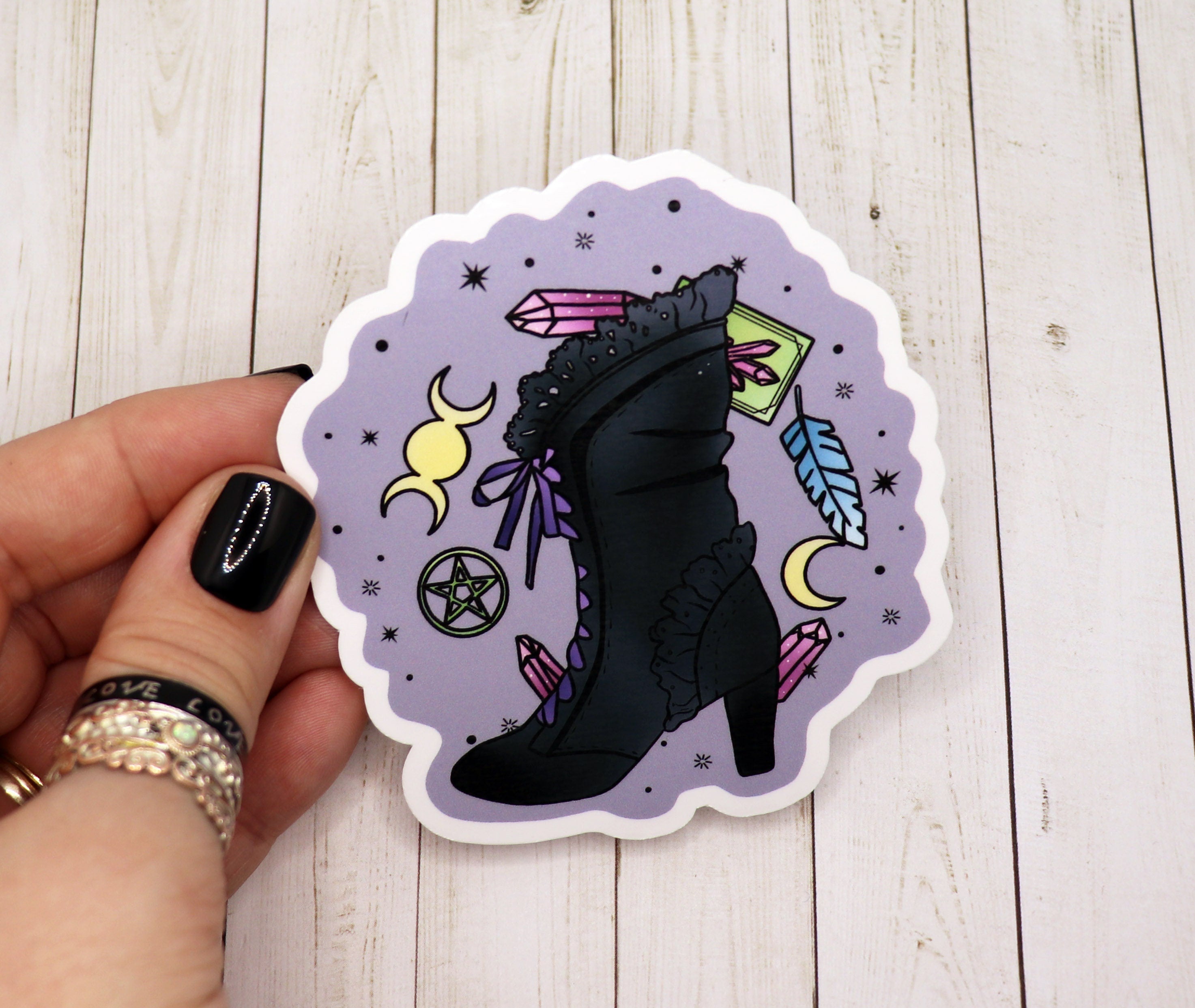 A vibrant Witch Boot Sticker featuring a stylish witch boot design on a matte vinyl surface, perfect for personalizing various items.