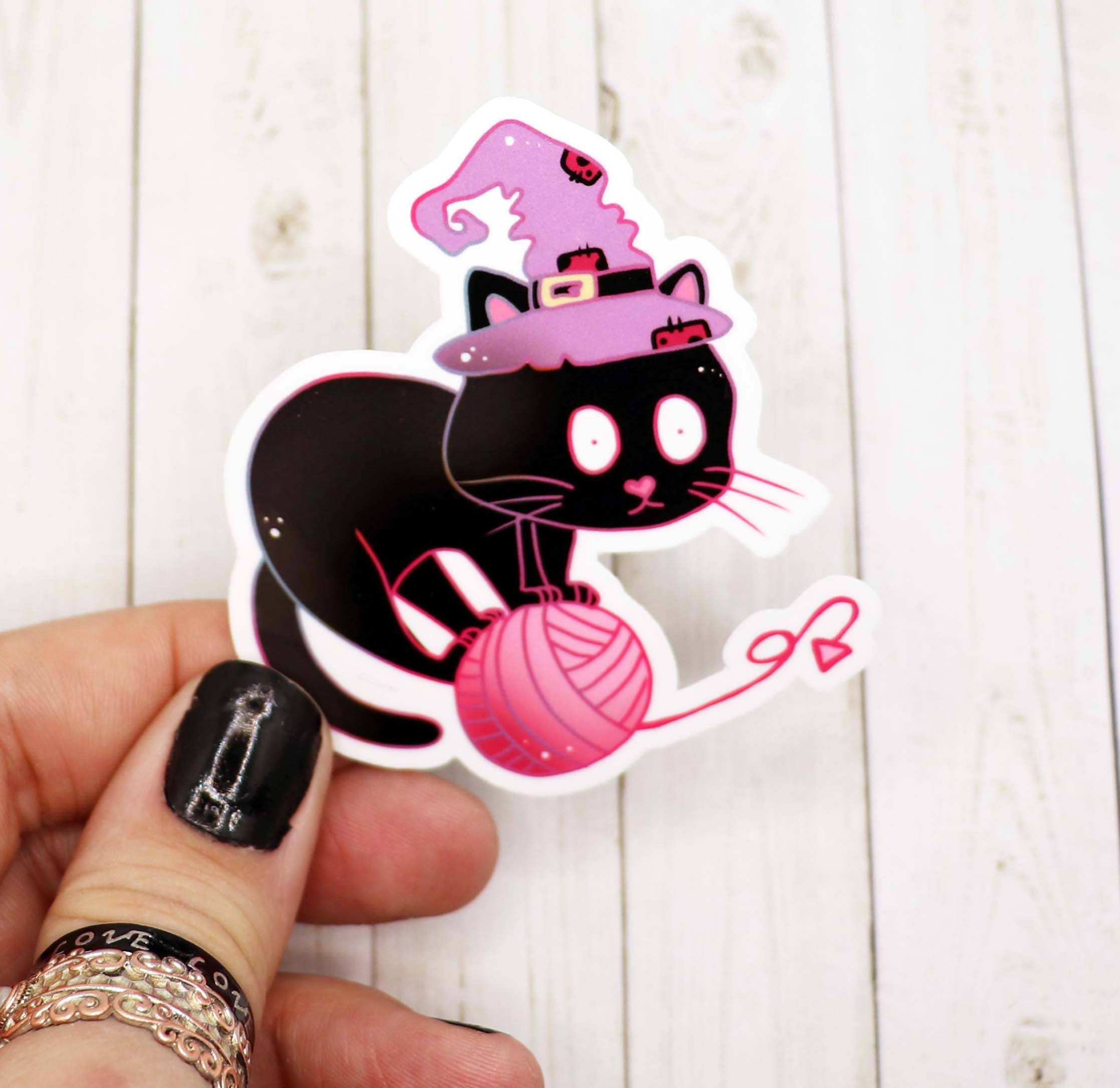 A whimsical Witch Cat Sticker featuring a playful cat with witch hat design, perfect for decorating various items.