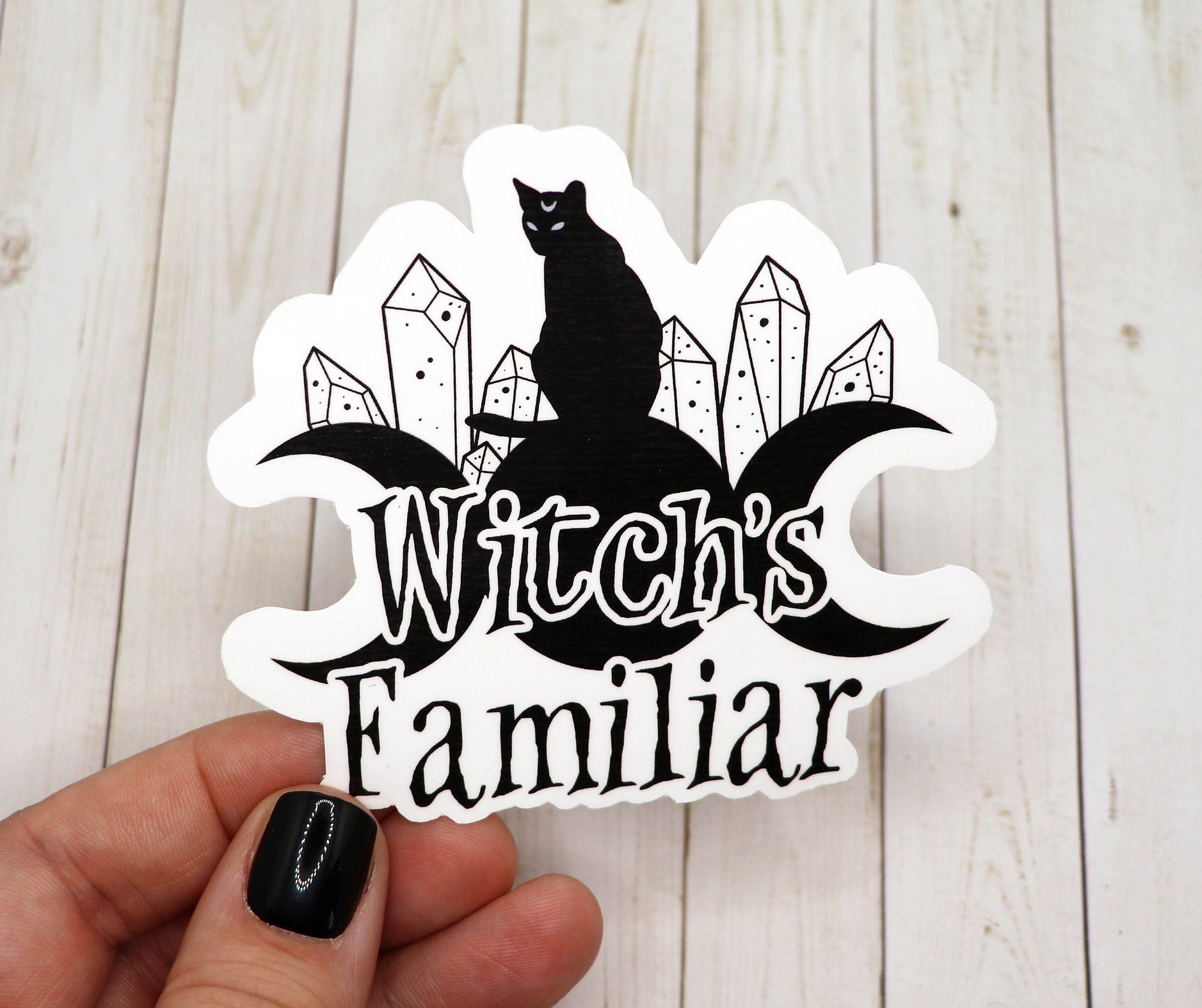 A stylish black cat sticker representing a witch's familiar, featuring intricate details and a matte finish.