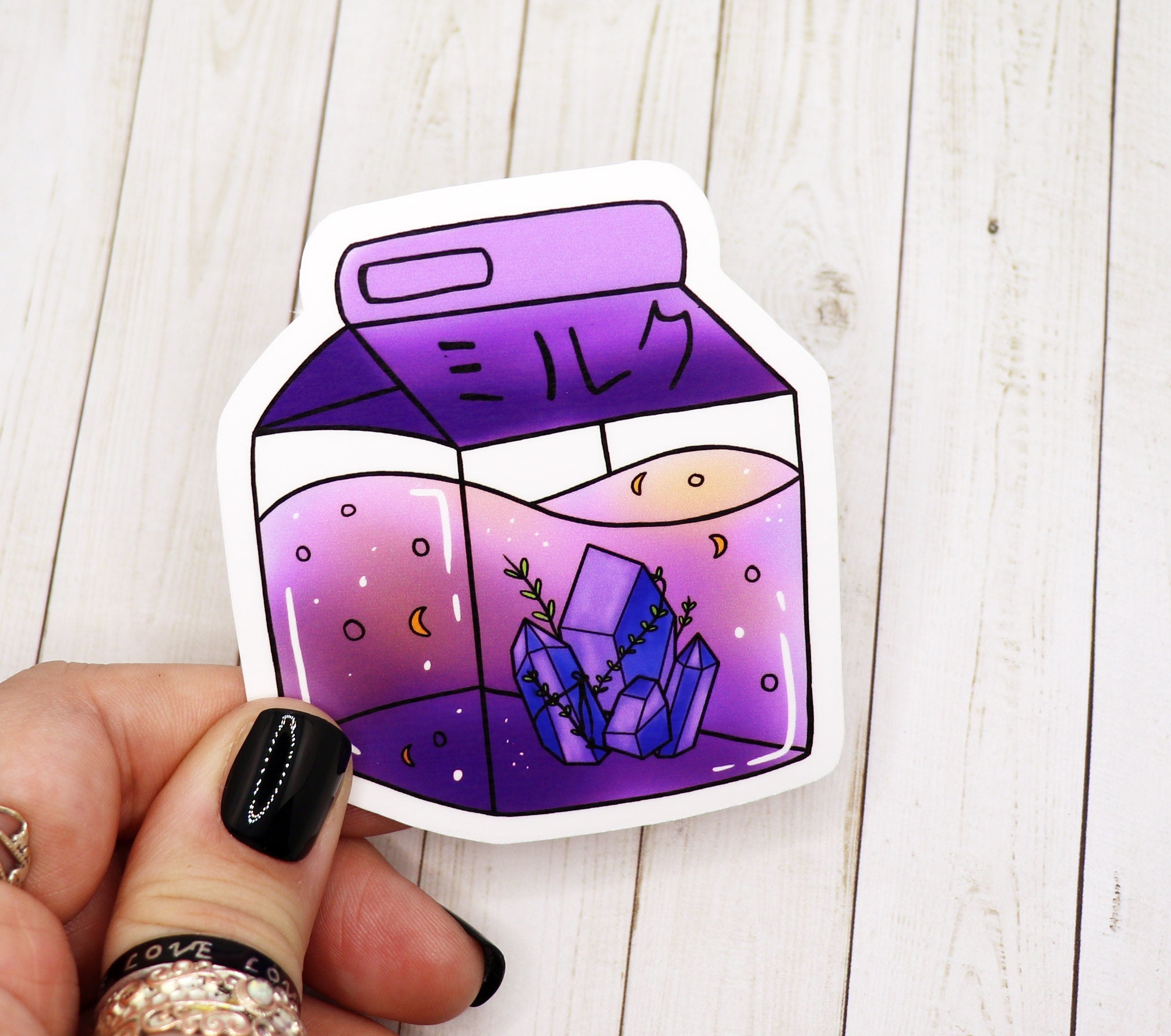 Witchy purple crystal milk carton sticker on a white background, showcasing its vibrant colors and unique design.