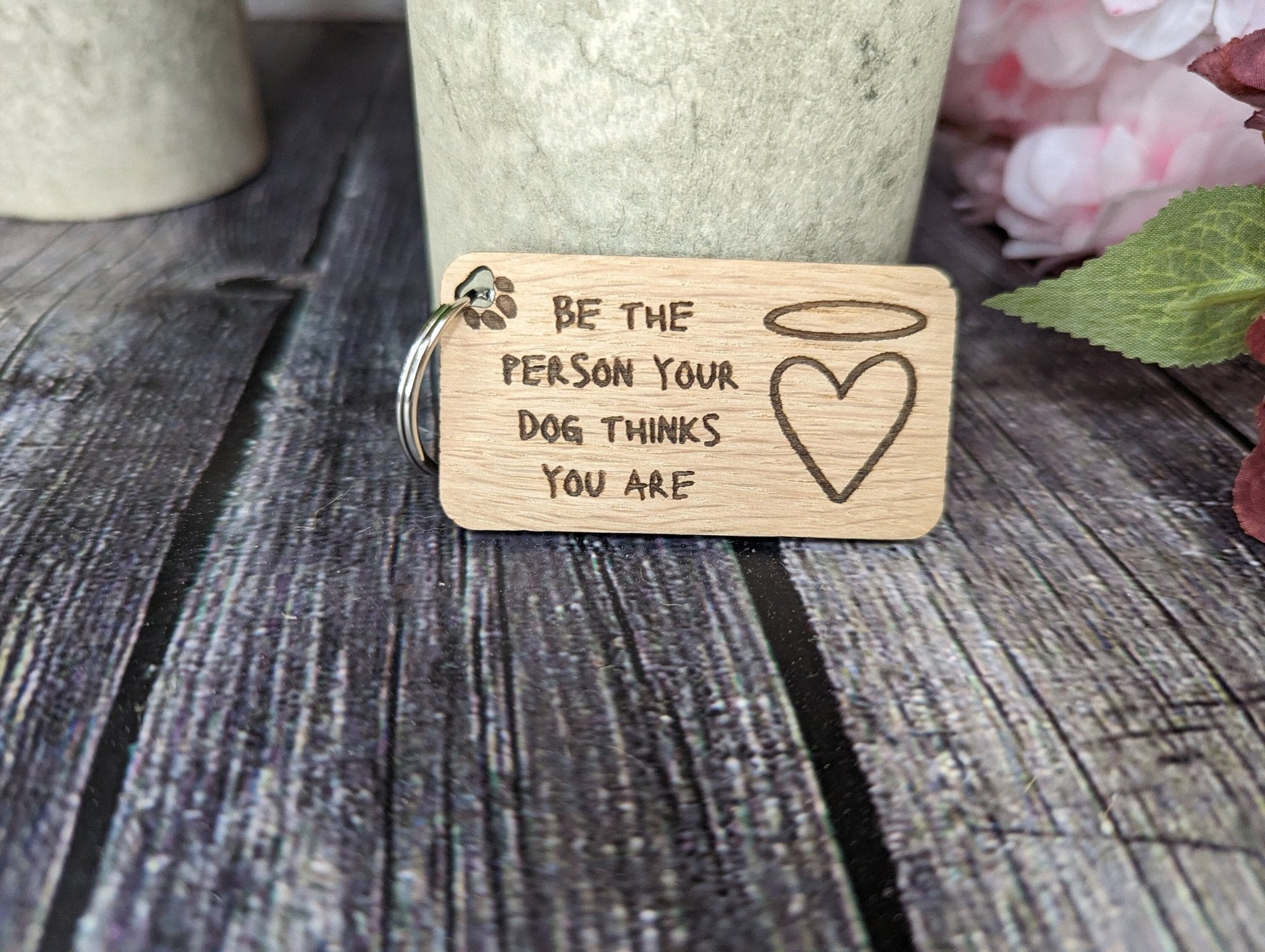 Eco-friendly wooden dog keyring with engraved motivational message, featuring a rustic design and crafted from sustainable materials.