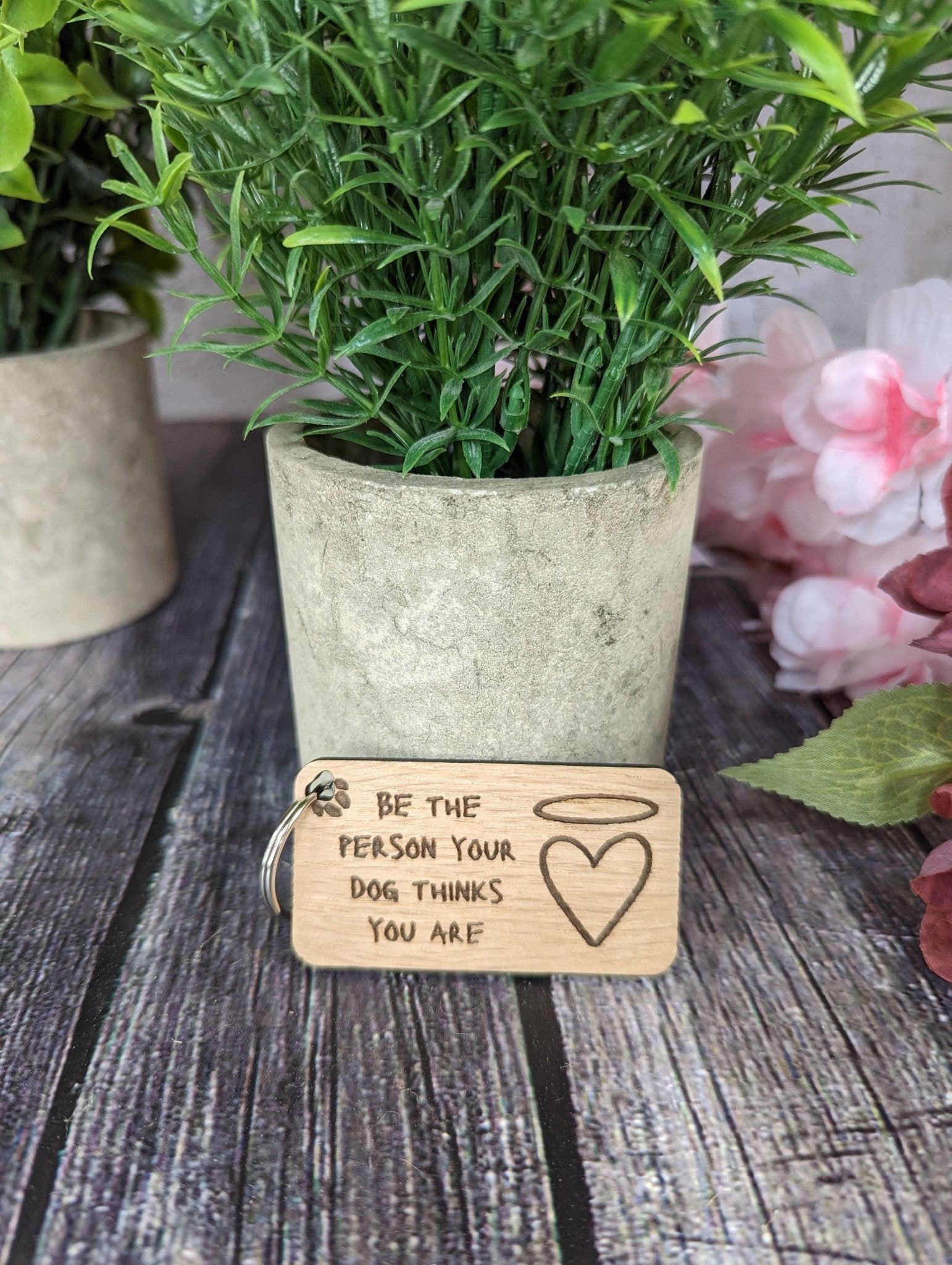 Eco-friendly wooden dog keyring with engraved motivational message, featuring a rustic design and crafted from sustainable materials.