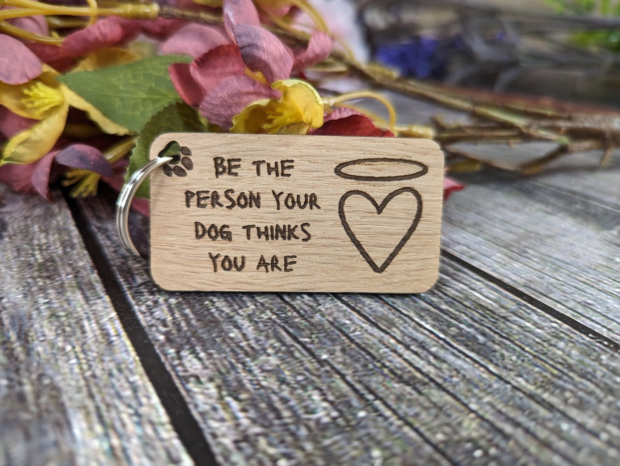 Eco-friendly wooden dog keyring with engraved motivational message, featuring a rustic design and crafted from sustainable materials.
