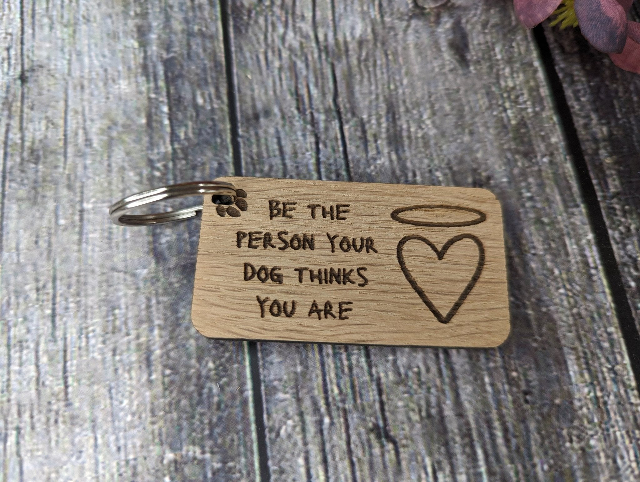 Eco-friendly wooden dog keyring with engraved motivational message, featuring a rustic design and crafted from sustainable materials.