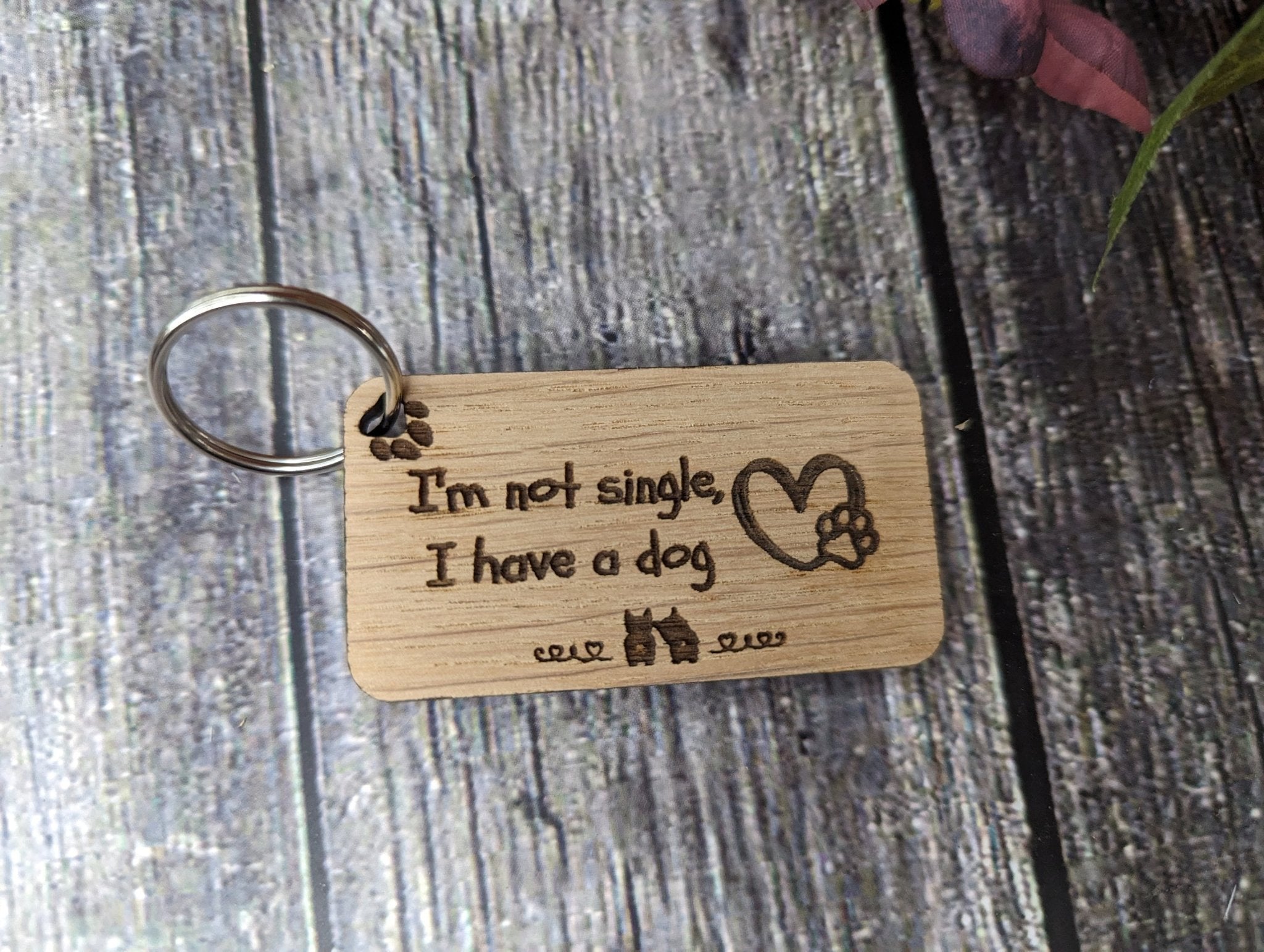 Eco-friendly wooden dog keyring with engraved message 'I'm Not Single, I Have a Dog', showcasing a playful design for dog lovers.