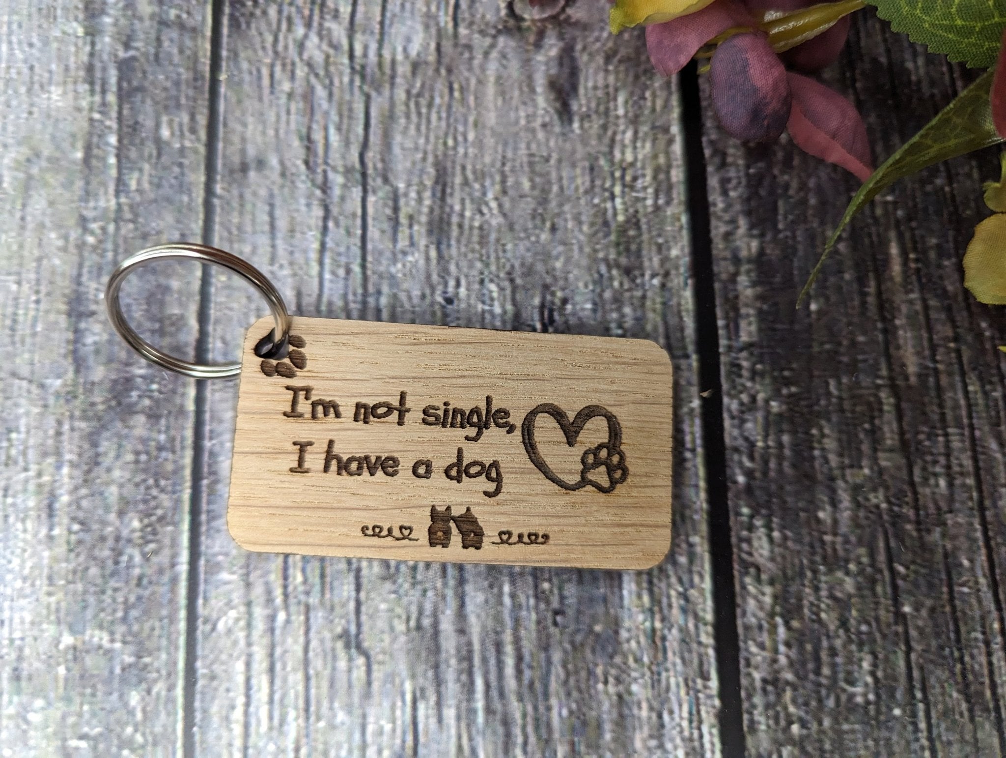 Eco-friendly wooden dog keyring with engraved message 'I'm Not Single, I Have a Dog', showcasing a playful design for dog lovers.
