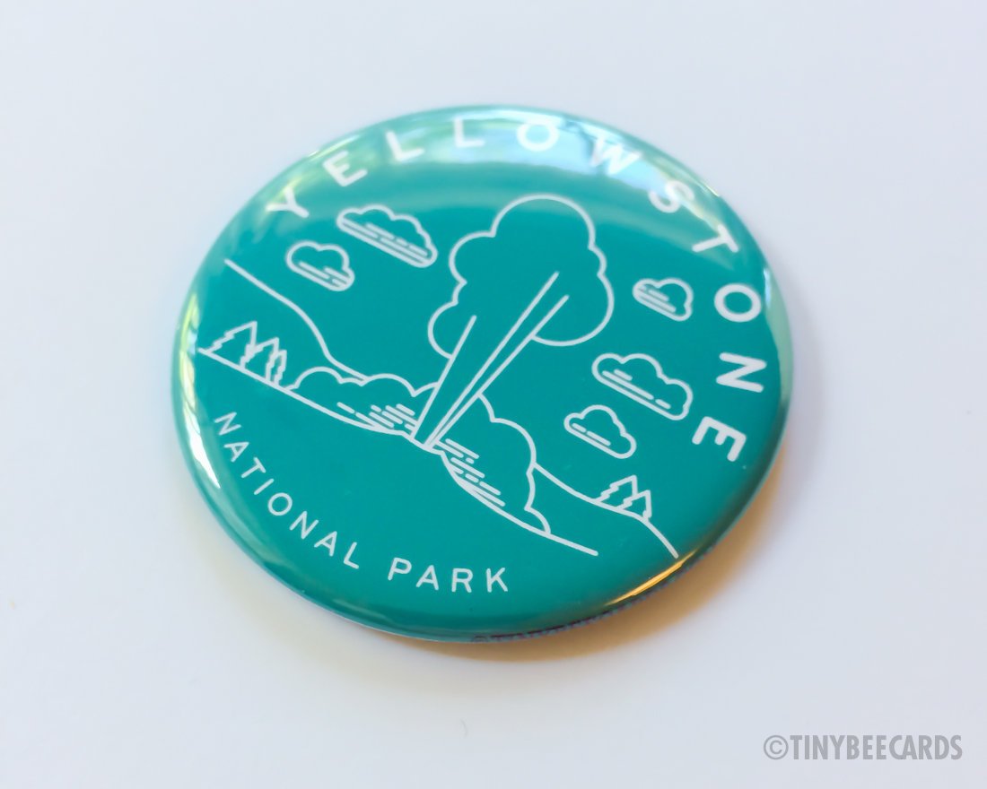 A 2.25-inch round magnet featuring Yellowstone National Park scenery with text, perfect for gifts.