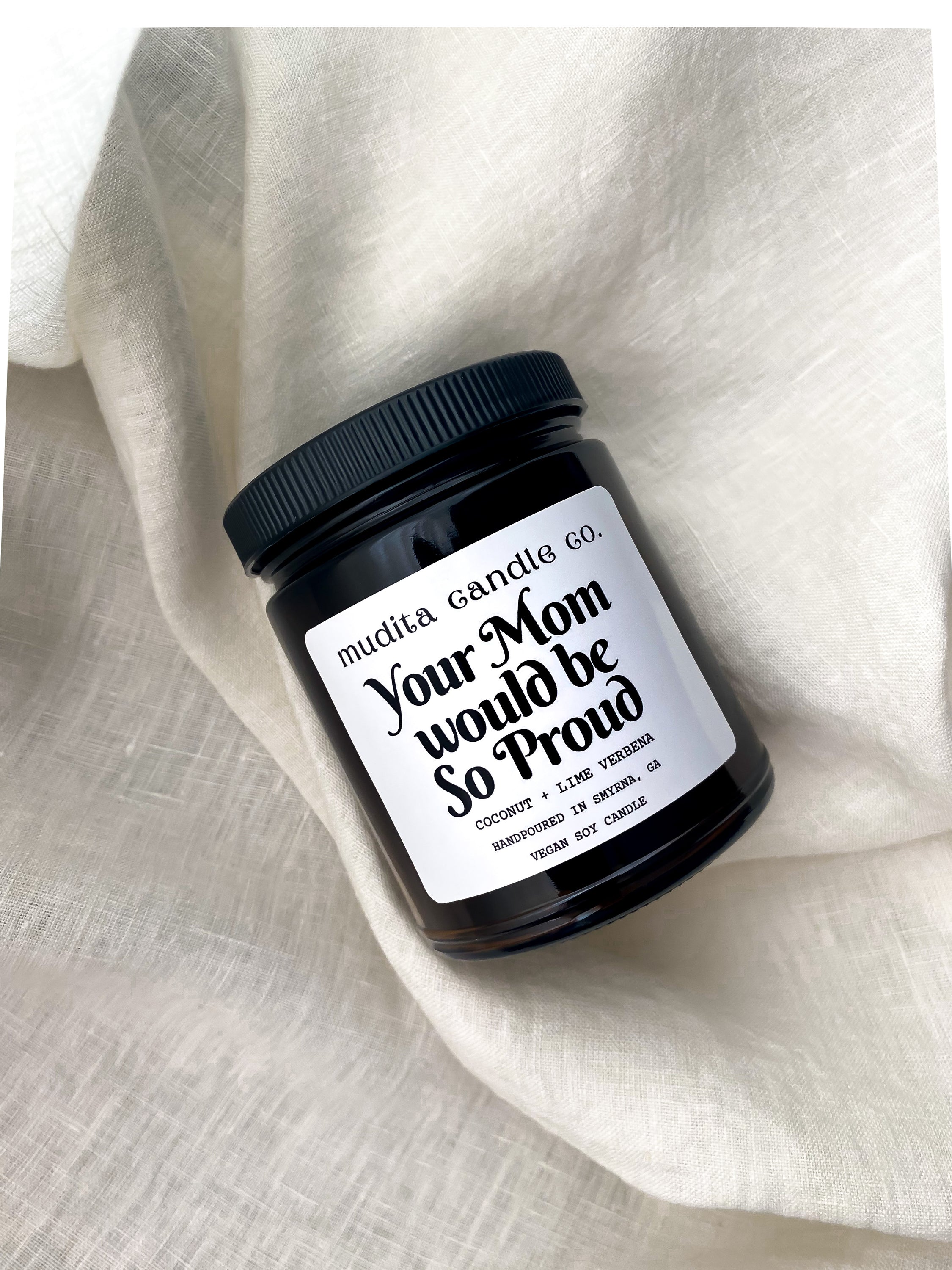 Your Mom Would Be So Proud 9oz Candle in amber glass jar with black lid, featuring tropical lime and coconut scent.