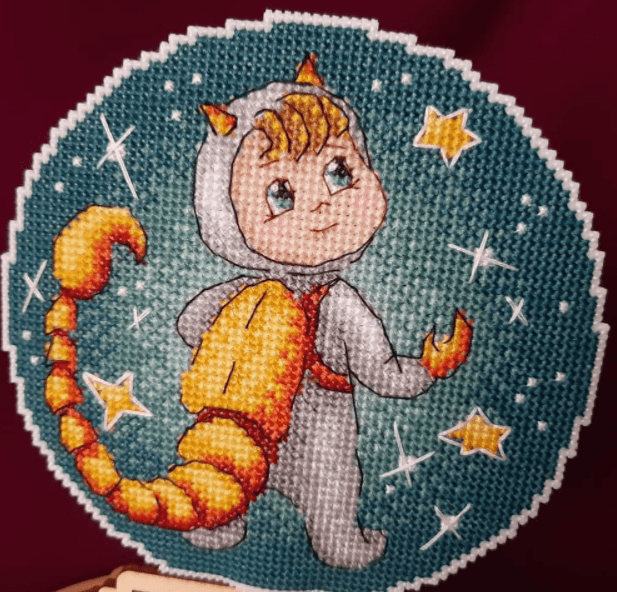 Scorpio SR-701 Plastic Canvas Counted Cross Stitch Kit featuring white canvas, colorful threads, and black and white chart.