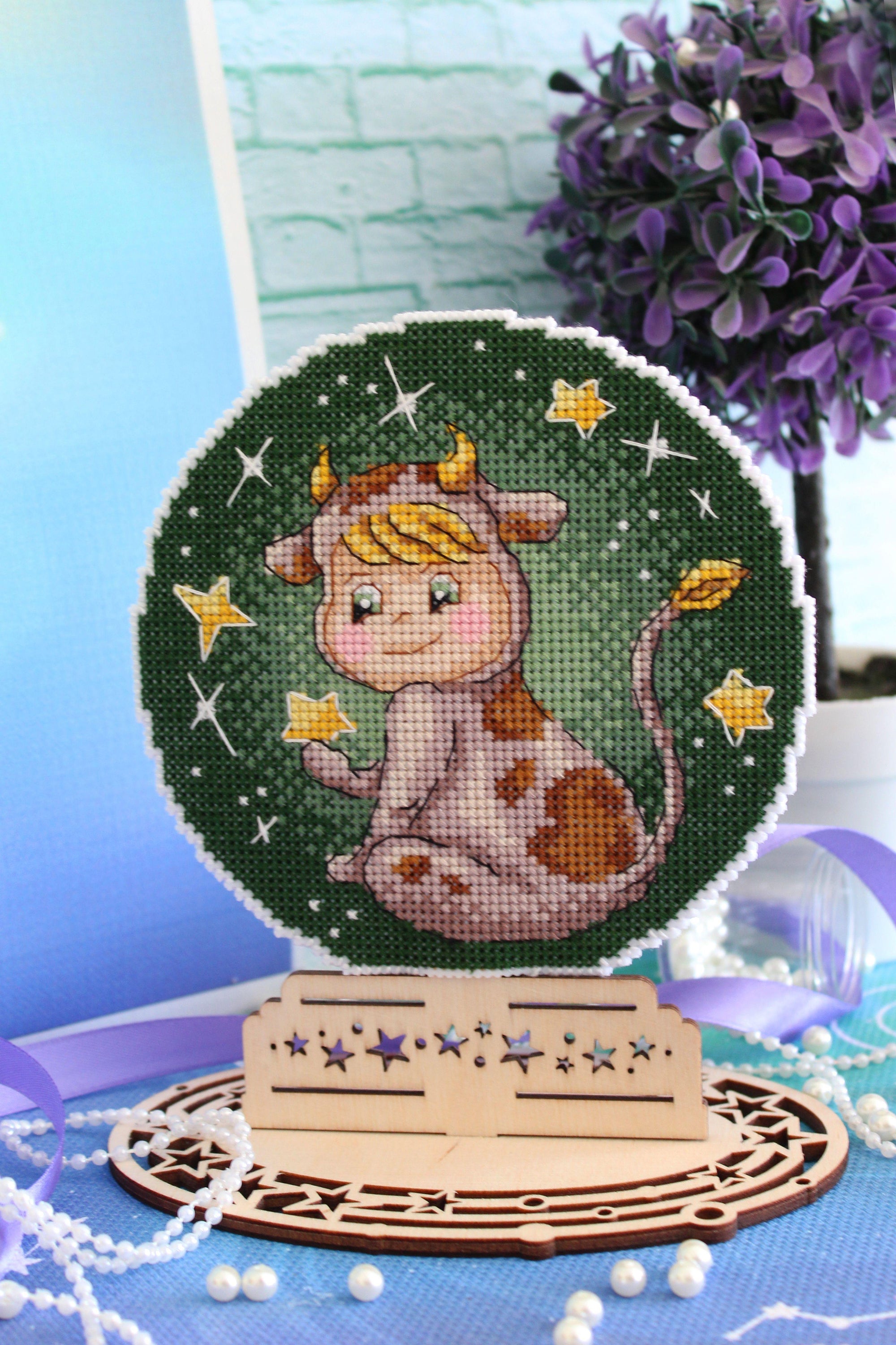 Taurus SR-699 Plastic Canvas Counted Cross Stitch Kit with threads, needle, and instructions, showcasing vibrant colors and zodiac design.