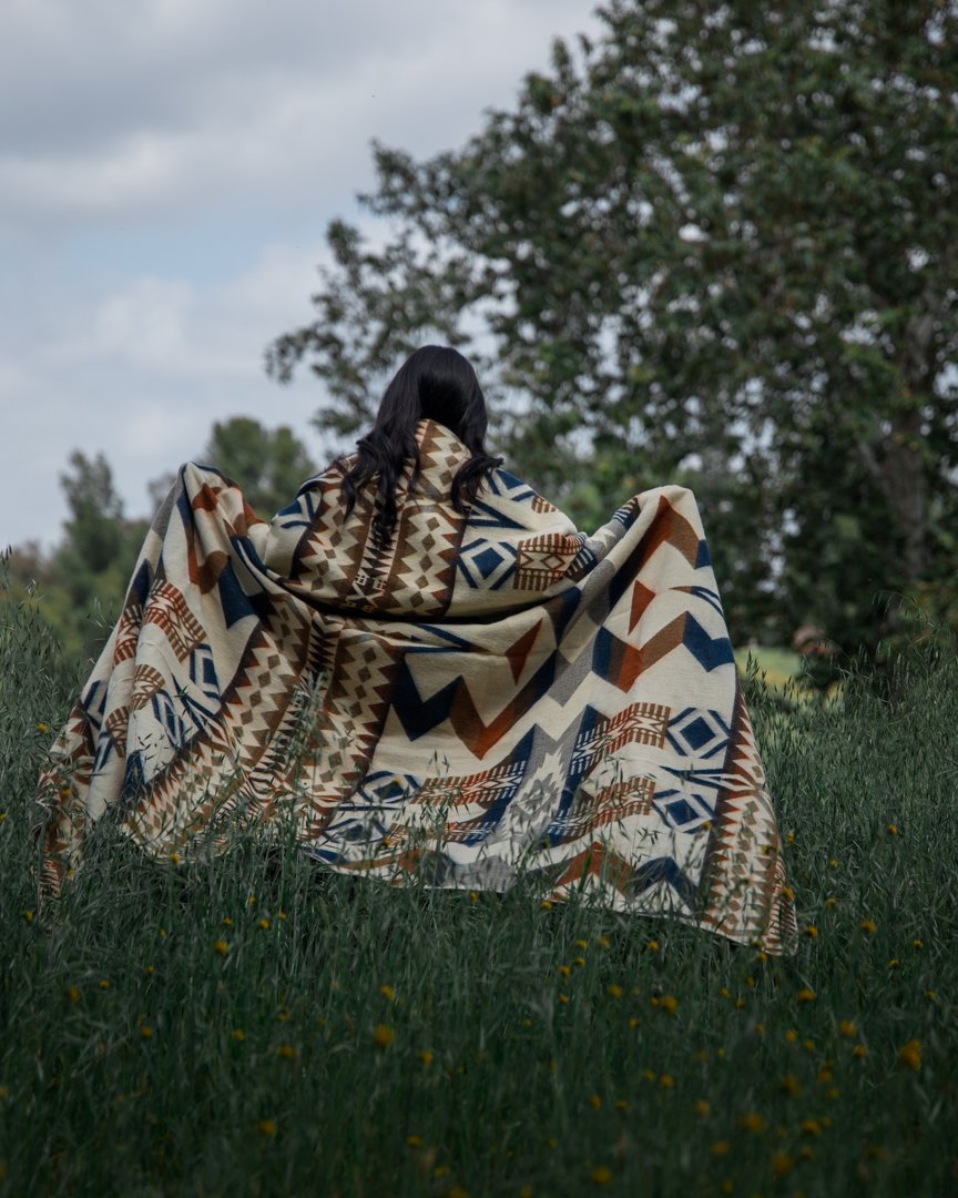 Awa Blanket - Earth, showcasing vibrant colors and intricate patterns, handcrafted by indigenous artisans from Ecuador.