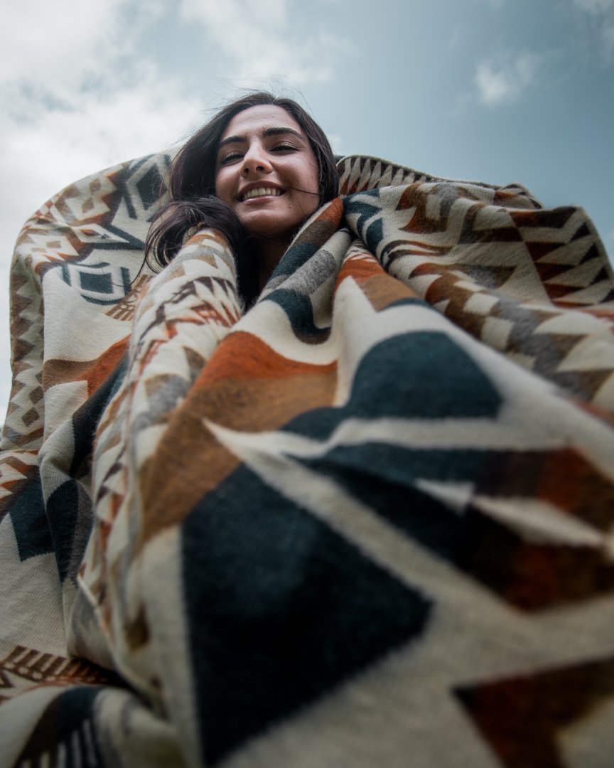 Awa Blanket - Earth, showcasing vibrant colors and intricate patterns, handcrafted by indigenous artisans from Ecuador.