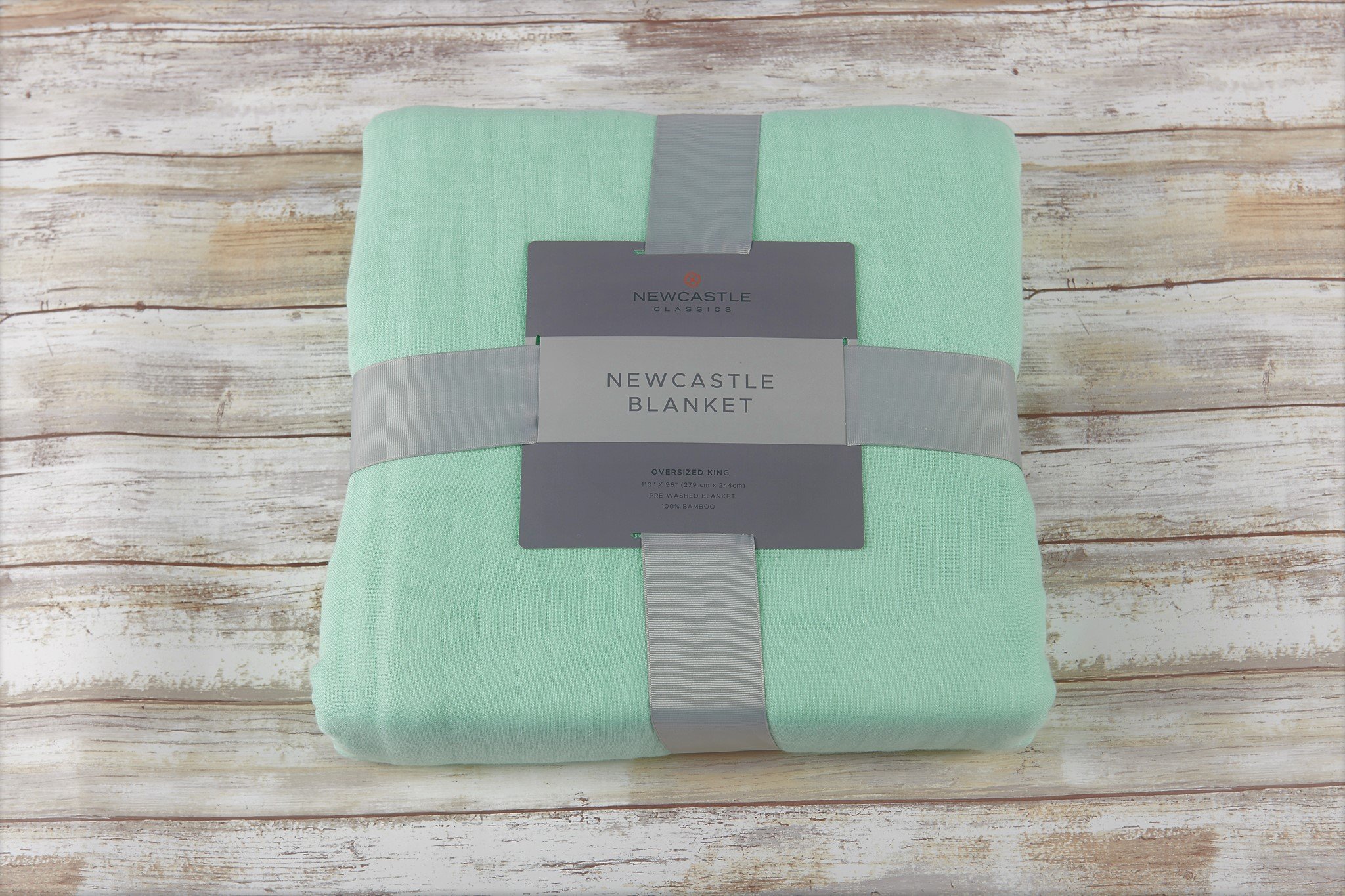 Oversized twin bamboo blanket in seafoam green, showcasing its soft texture and generous size, perfect for cozying up or layering.