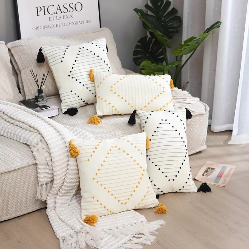 Boho tassel style tufted square cushion covers in a stylish living room setting, showcasing their elegant design and vibrant colors.
