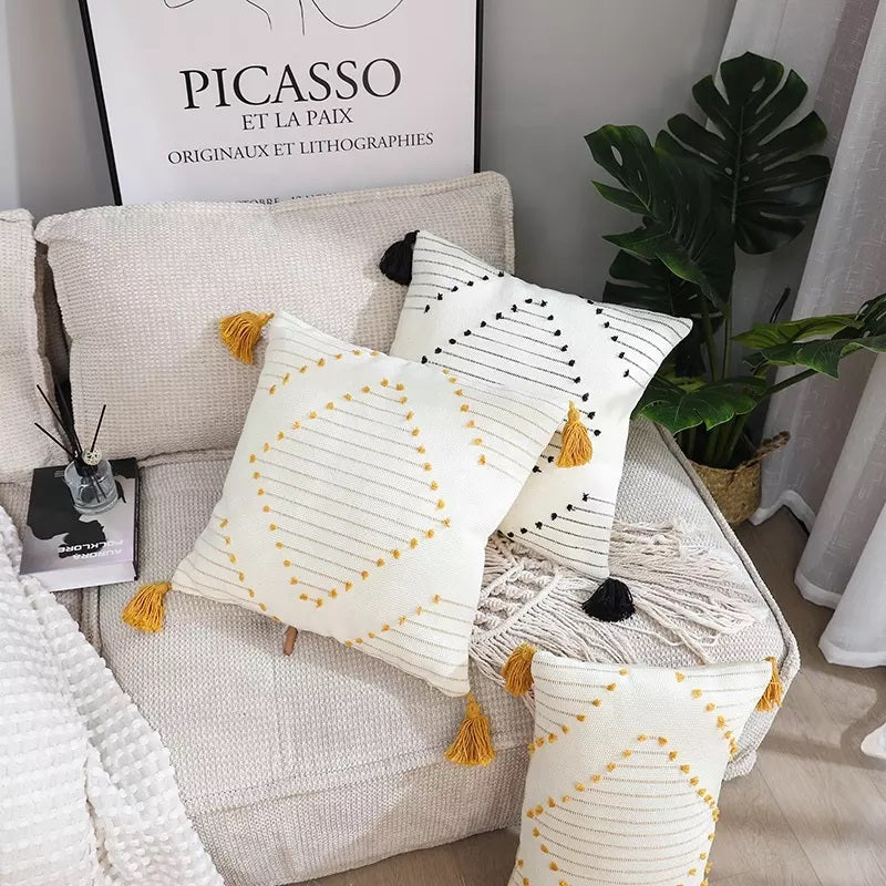Boho tassel style tufted square cushion covers in a stylish living room setting, showcasing their elegant design and vibrant colors.