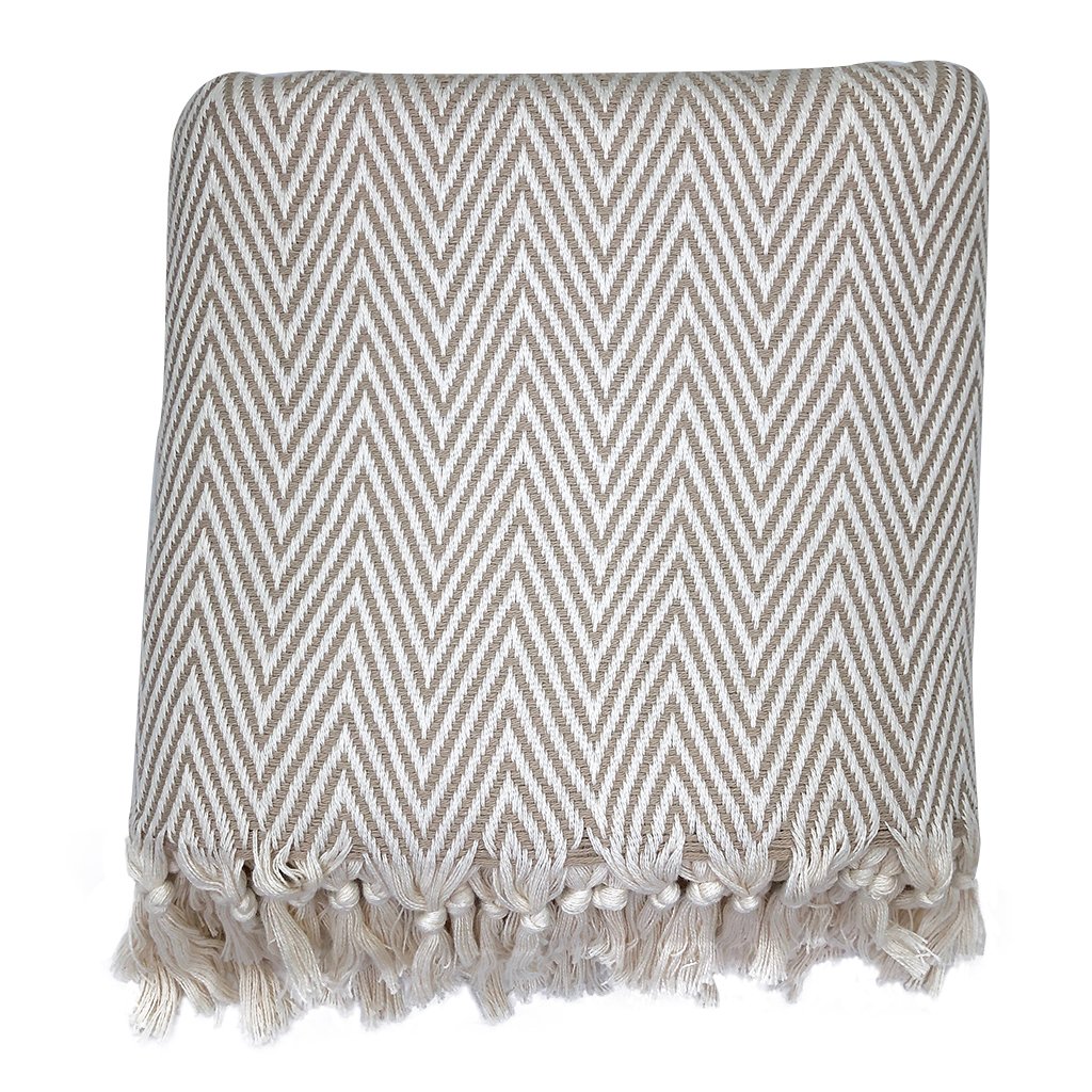 A cozy Chunky Chevron Turkish Throw featuring an intricate chevron pattern and hand-knotted fringe, perfect for home decor.