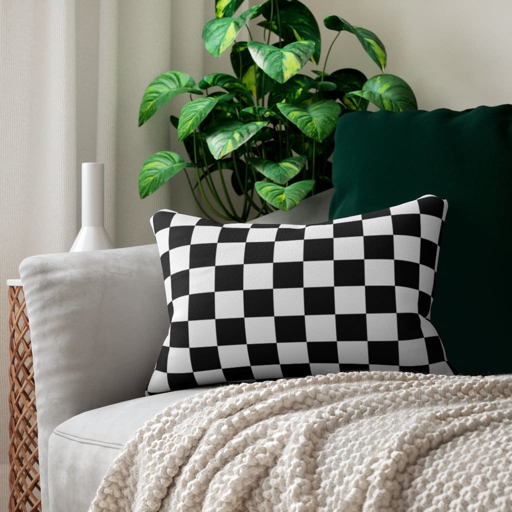 Decorative lumbar throw pillow featuring a black and white checkered pattern, made from spun-polyester with a concealed zipper.